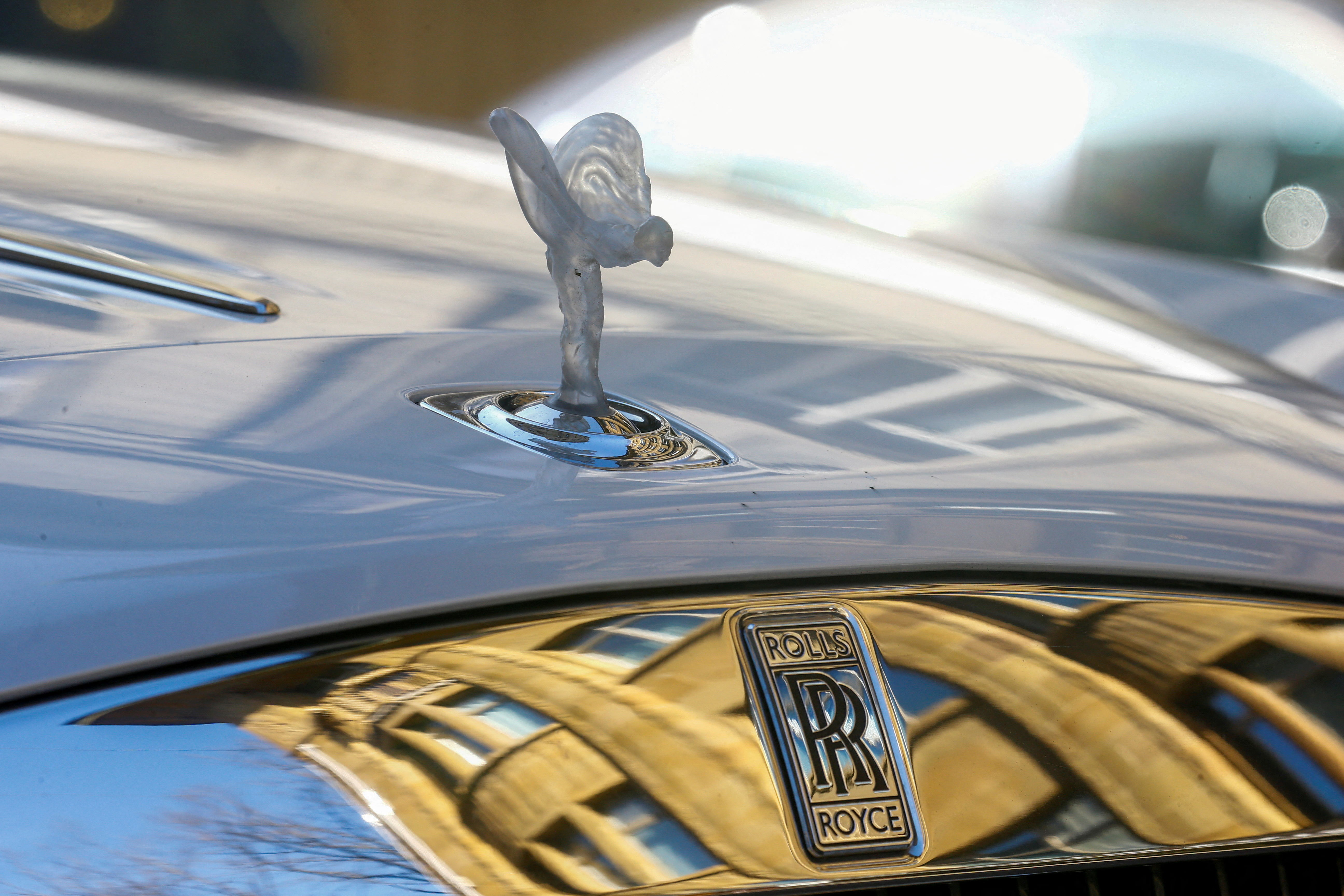 FILE PHOTO: The mascot, the so-called 'Spirit of Ecstasy' or 'Emily', and the company logo are seen on the bonnet of a Rolls-Royce car in Zurich, Switzerland March 30, 2021. REUTERS/Arnd Wiegmann/File Photos