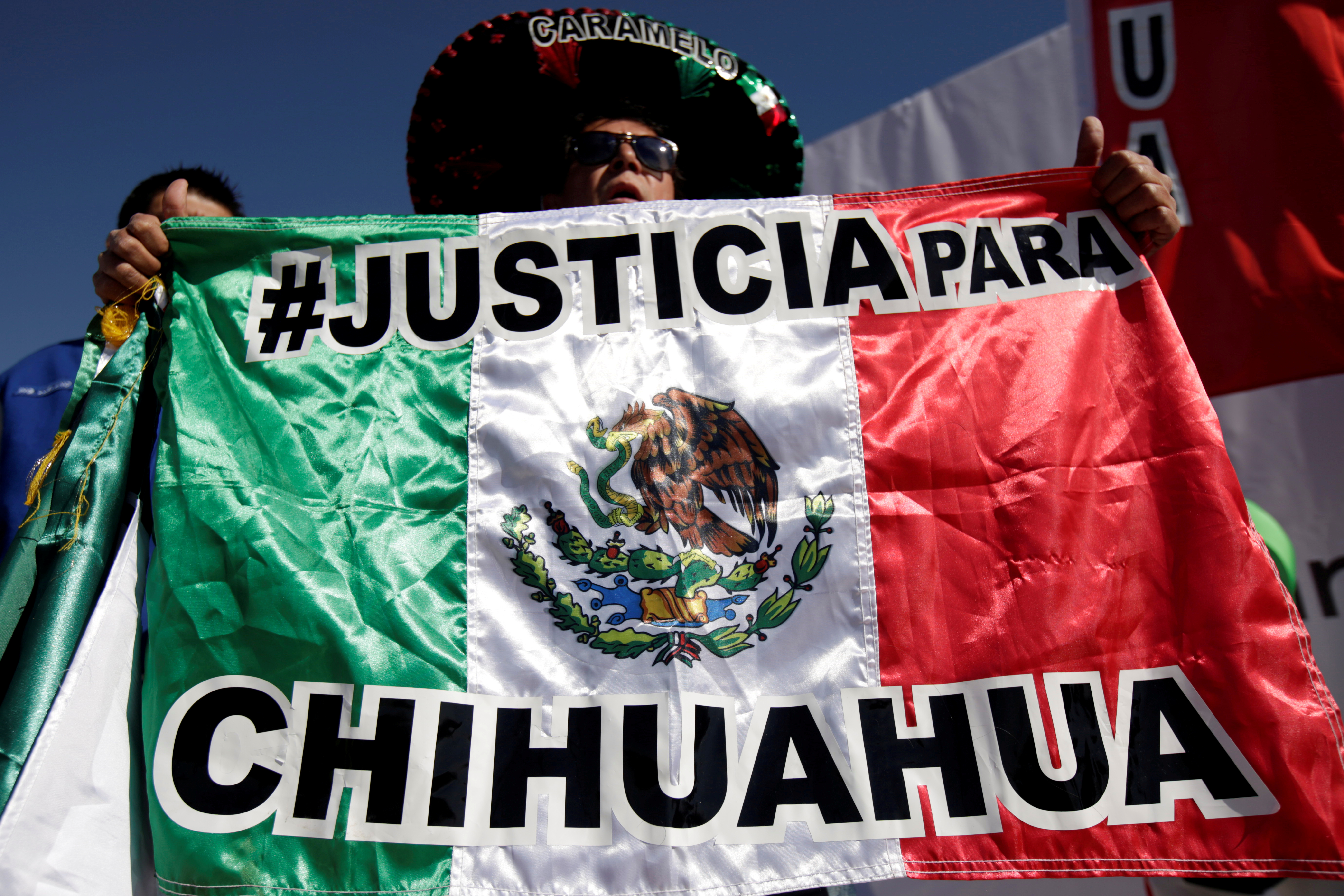 File, Man holding flag in Ciudad Juarez (REUTERS/Jose Luis Gonzalez/File Photo)