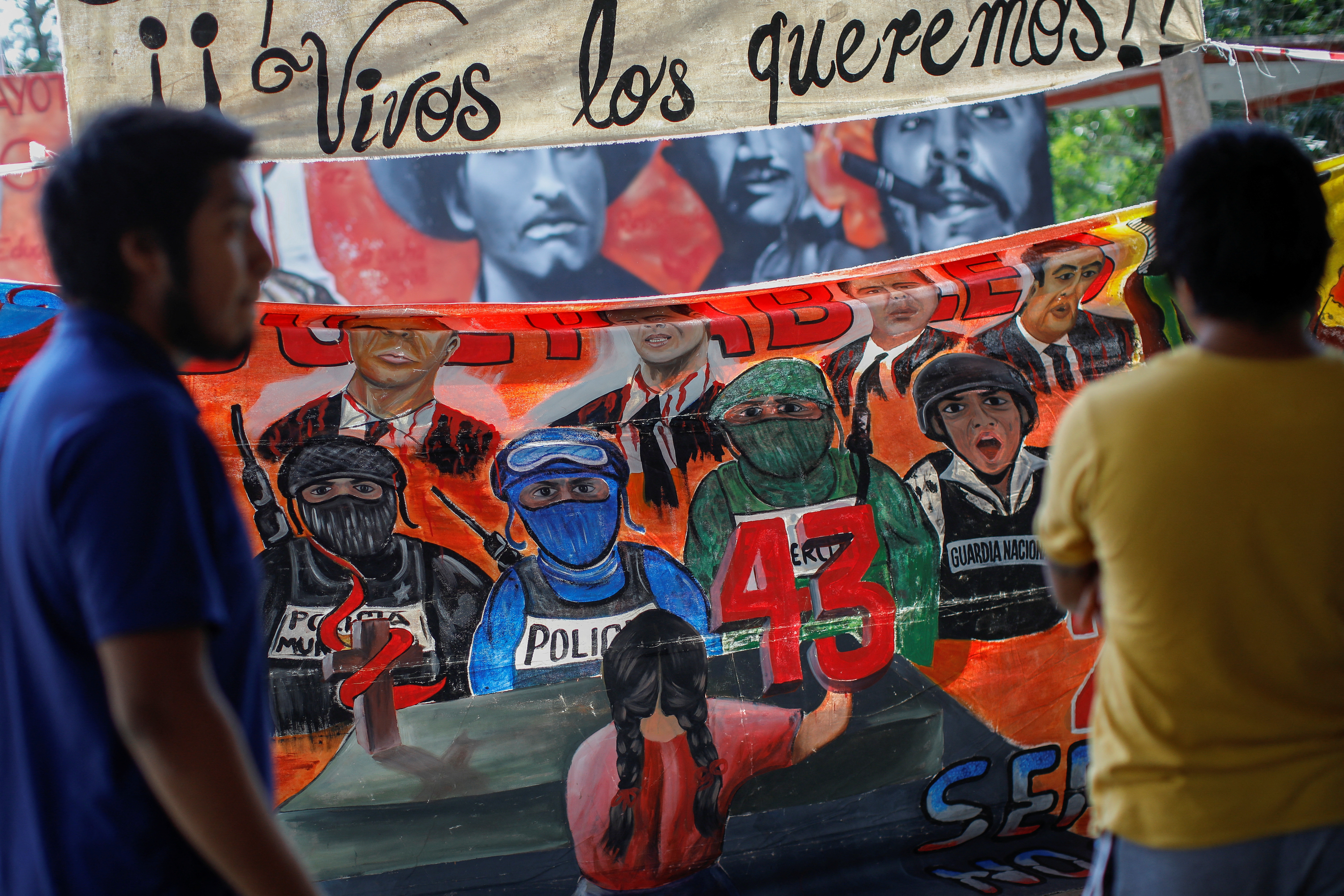 Students of Ayotzinapa teachers training college "Raul Isidro Burgos" place a banner before the presentation of the report by IACHR about the disappearance of the 43 students, at the Ayotzinapa College "Raul Isidro Burgos" in Tixtla, Guerrero state, Mexico, November 15, 2022. REUTERS/Raquel Cunha