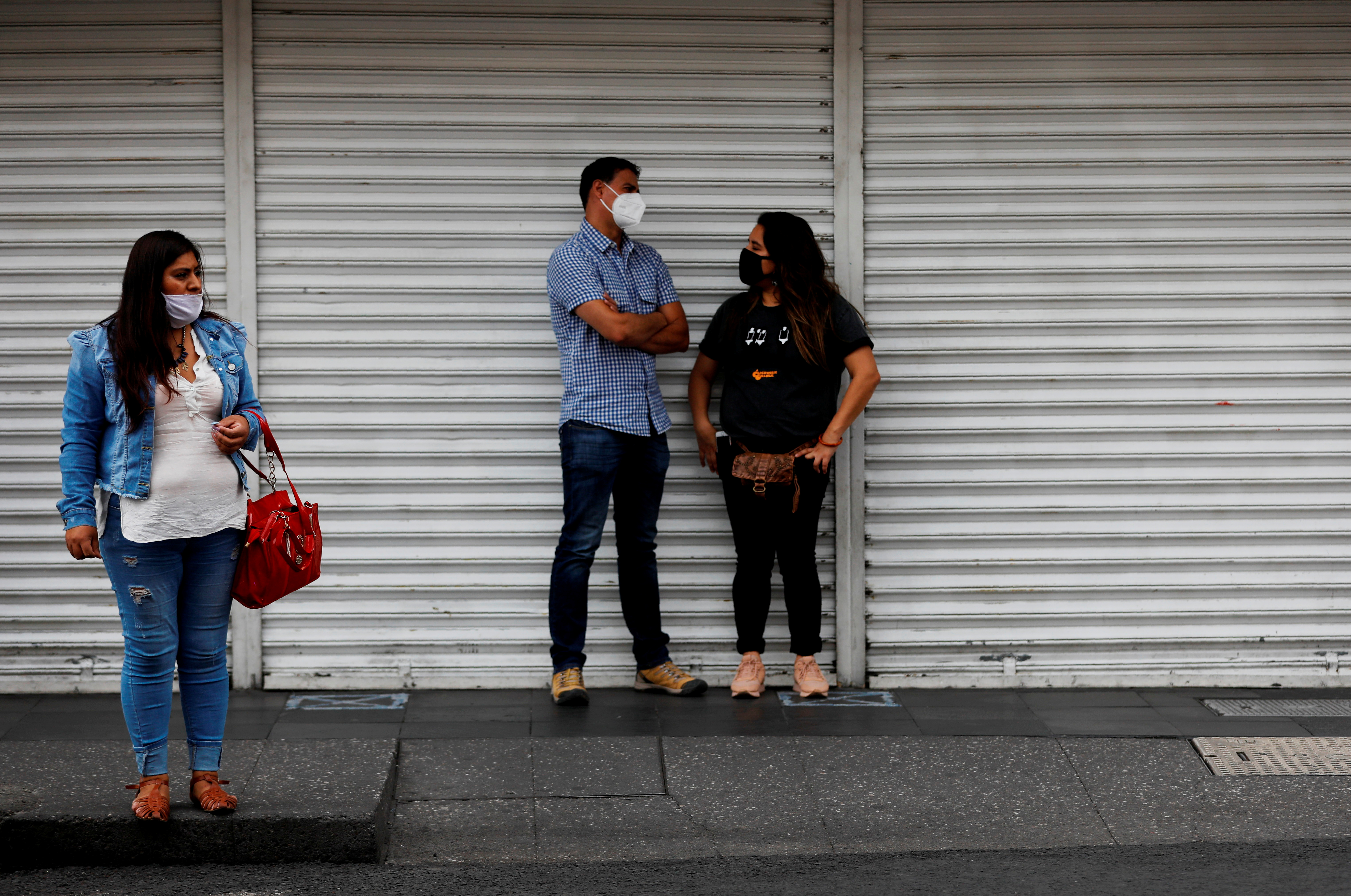 People stand near Zocalo Square, as the coronavirus disease (COVID-19) outbreak continues, in Mexico City, Mexico July 31, 2020. REUTERS/Carlos Jasso