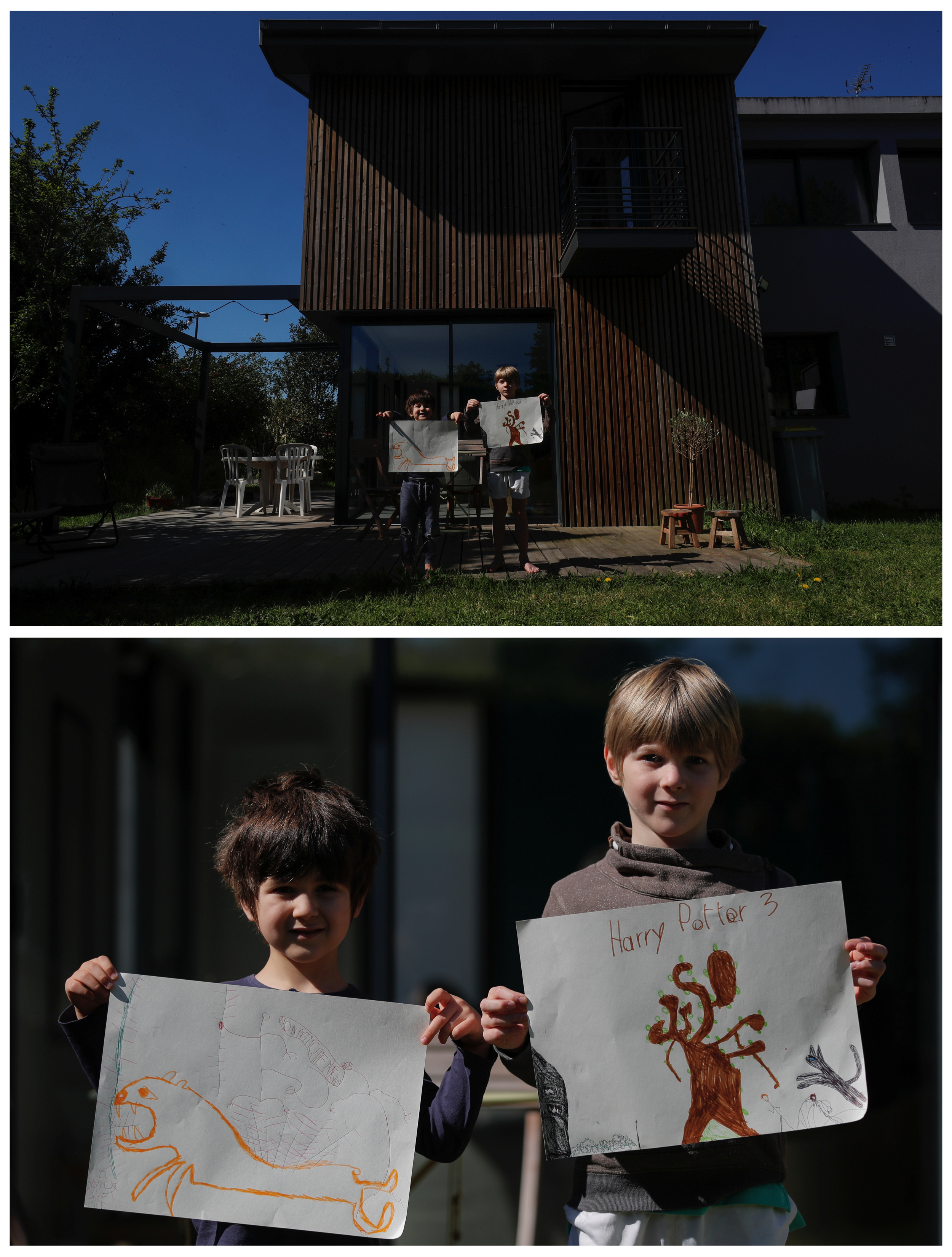 Come, 5, y Lilian, 9, exhiben dibujos que hicieron durante el brote de coronavirus, parados en el frente de su casa en Reze, Francia, el 15 de abril pasado.