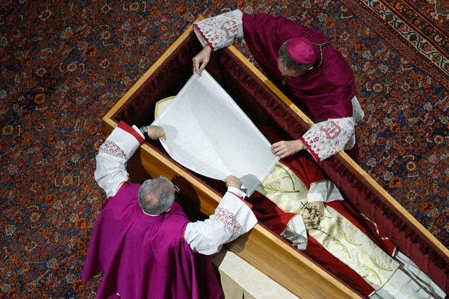 El arzobispo Georg Gaenswein cubre el rostro de Benedicto mientras yace en un ataúd en la Basílica de San Pedro antes de su funeral en el Vaticano, el 4 de enero de 2023. Vatican Media/Folleto a través de REUTERS 