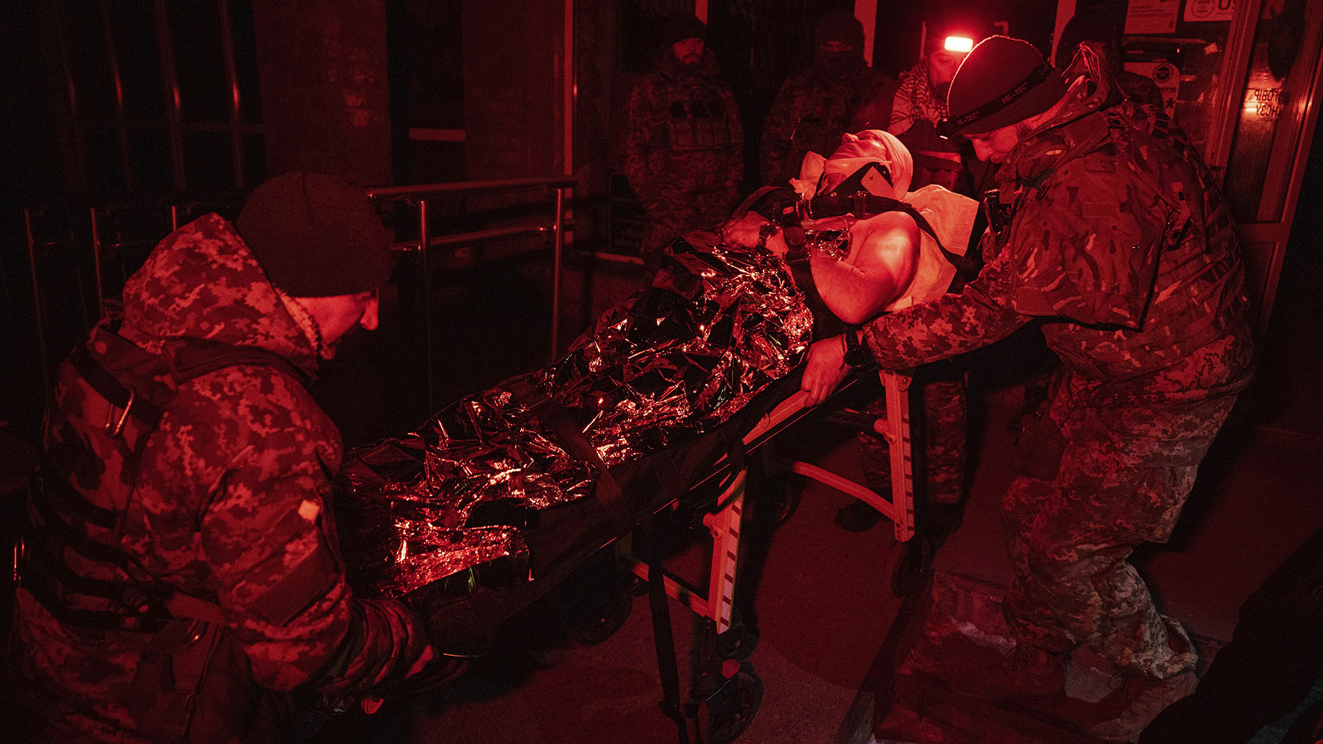Ukrainian military medics transport their wounded comrade evacuated from the battlefield to a hospital in the Donetsk region, Ukraine, Monday, Jan. 9, 2023. (AP Photo/Evgeniy Maloletka)