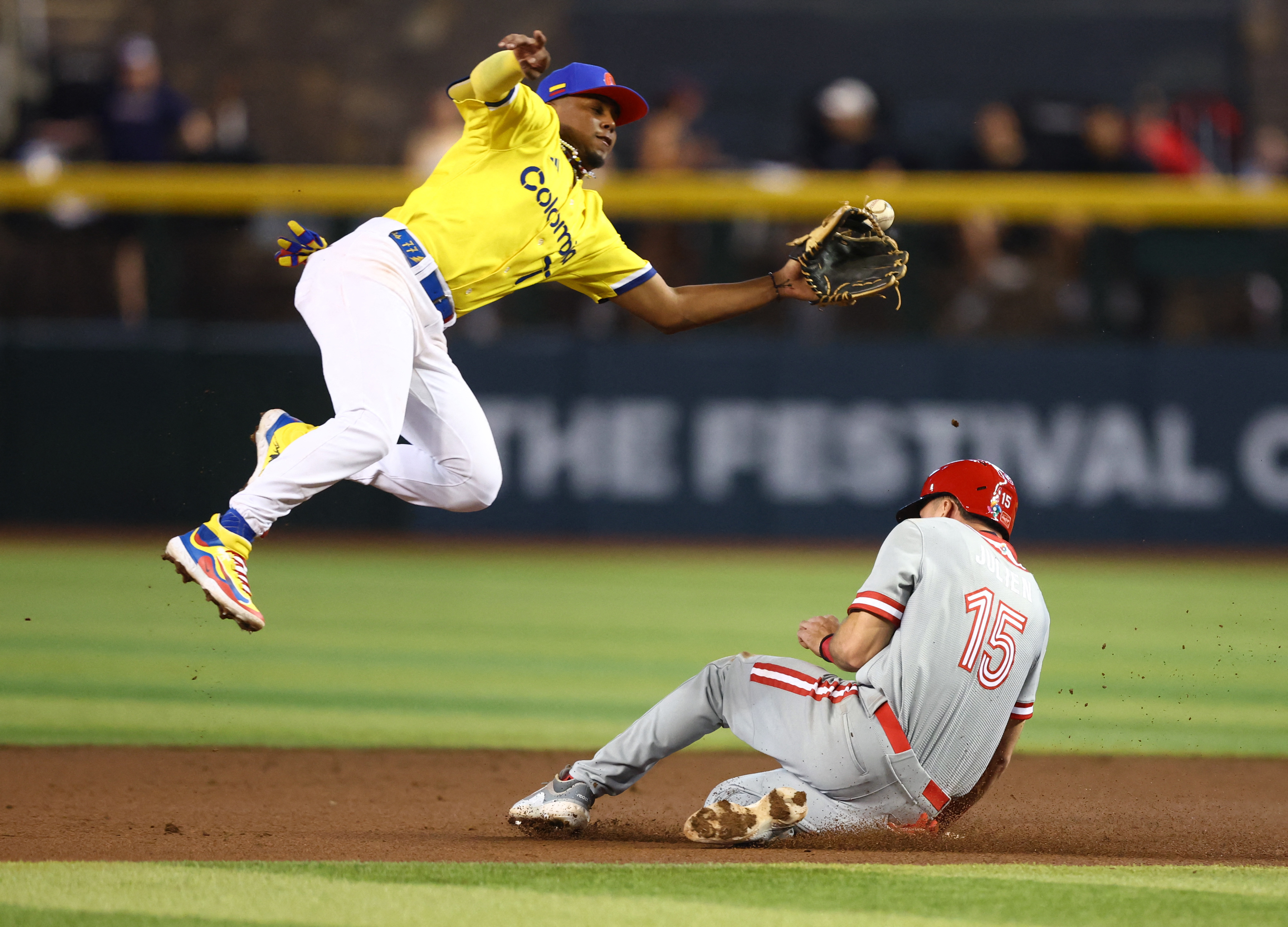 Mar 14, 2023; Phoenix, Arizona, USA; Canada base runner Edouard Julien (15) steals second base ahead of the ball to Colombia shortstop Dayan Frias in the first inning during the World Baseball Classic at Chase Field. Mandatory Credit: Mark J. Rebilas-USA TODAY Sports