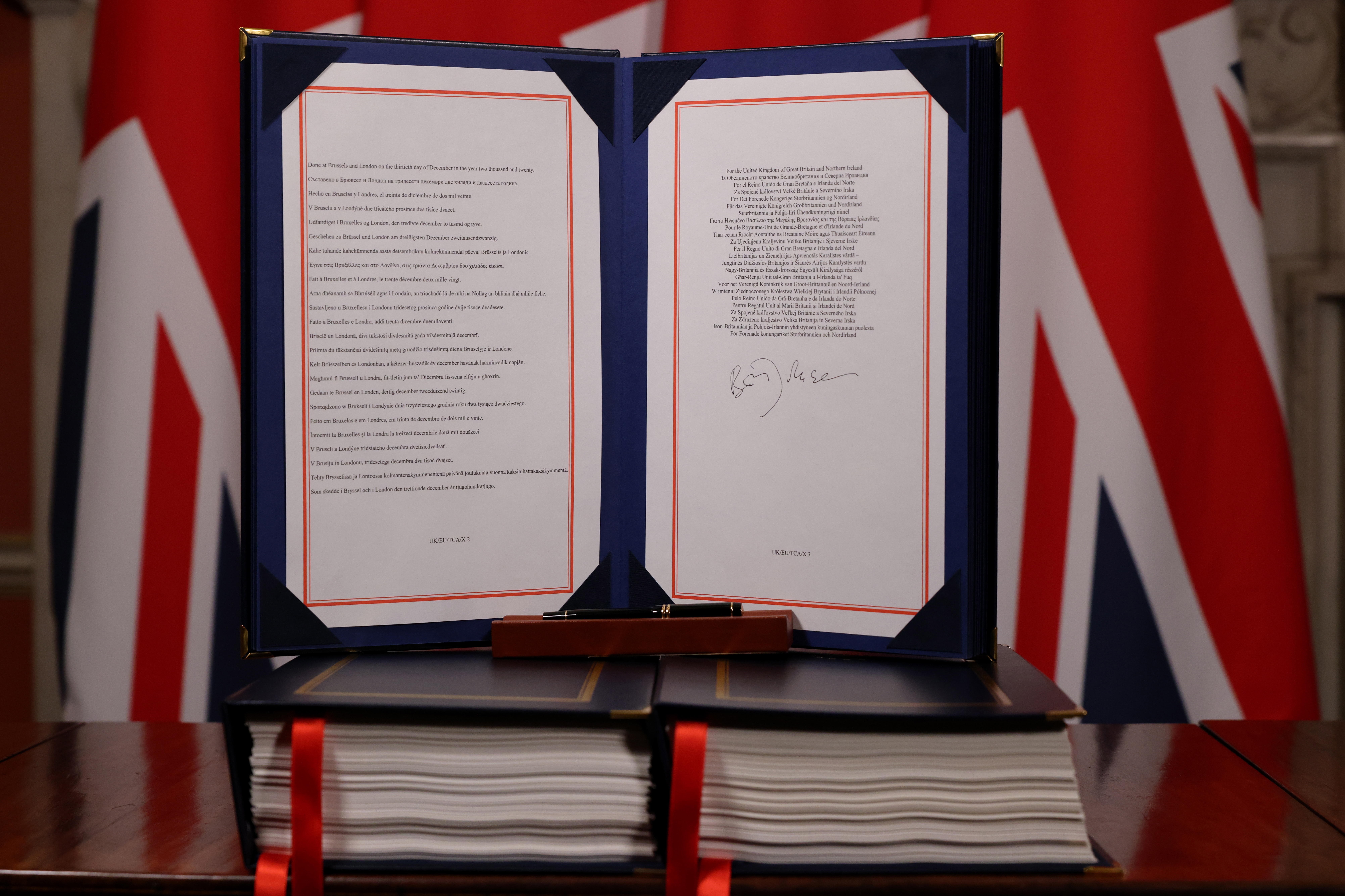 Una foto distribuida por el 10 Downing Street muestra el Acuerdo de Comercio y Cooperación entre el Reino Unido y la UE, el acuerdo comercial Brexit, firmado por el primer ministro británico Boris Johnson, en Londres, Gran Bretaña, el 30 de diciembre de 2020

