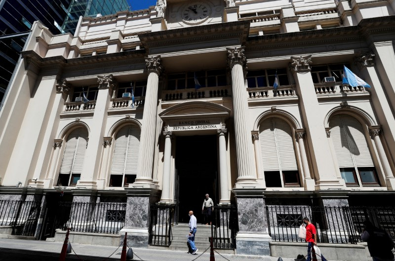 Stock Photo - Pedestrians walk in front of the facade of the central bank of Argentina (BCRA), in Buenos Aires.  Dec 7, 2021. REUTERS/Agustin Marcarian