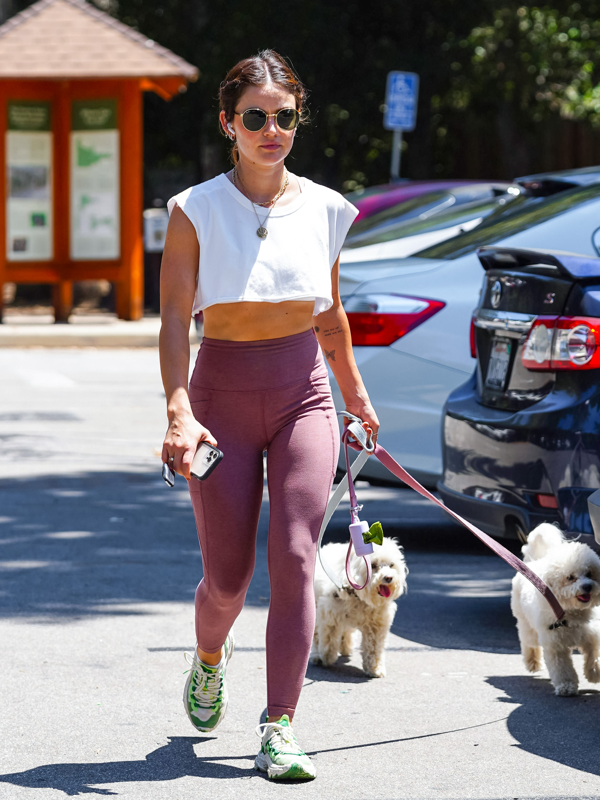 Lucy Hale hit the streets of Studio City for a workout, donning a jogging outfit and taking the opportunity to take her pets for a walk.  She wore leggings and a white top, in addition, she was listening to music on her headphones