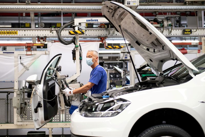 FILE PHOTO: A man works on a Volkswagen group car assembly line in Wolfsburg, Germany, April 27, 2020. Swen Pfoertner/Pool via REUTERS