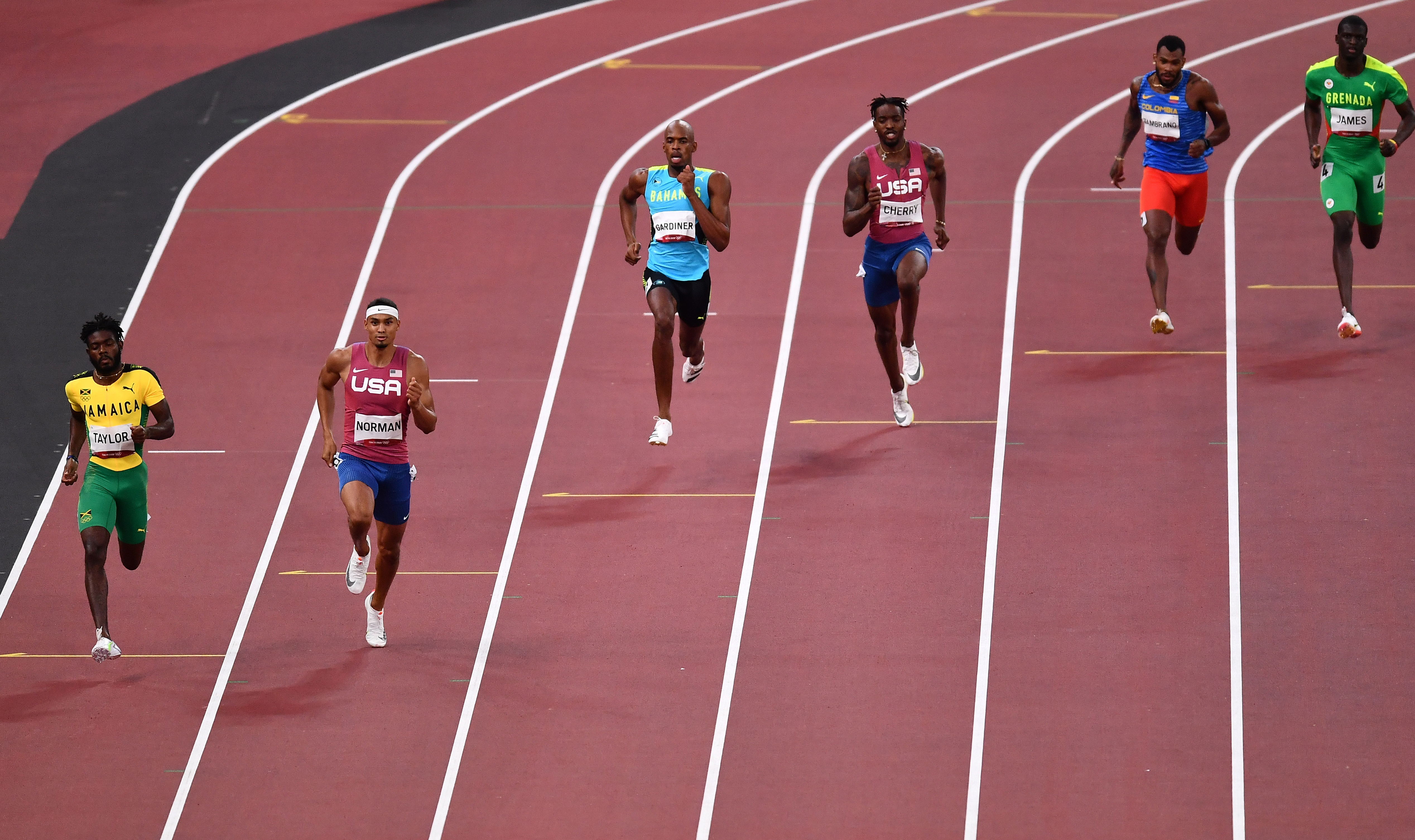 Tokyo 2020 Olympics - Athletics - Men's 400m - Final - Olympic Stadium, Tokyo, Japan - August 5, 2021. Steven Gardiner of the Bahamas in action on his way to winning gold alongside Michael Norman of the United States and bronze medallist, Kirani James of Grenada REUTERS/Clodagh Kilcoyne