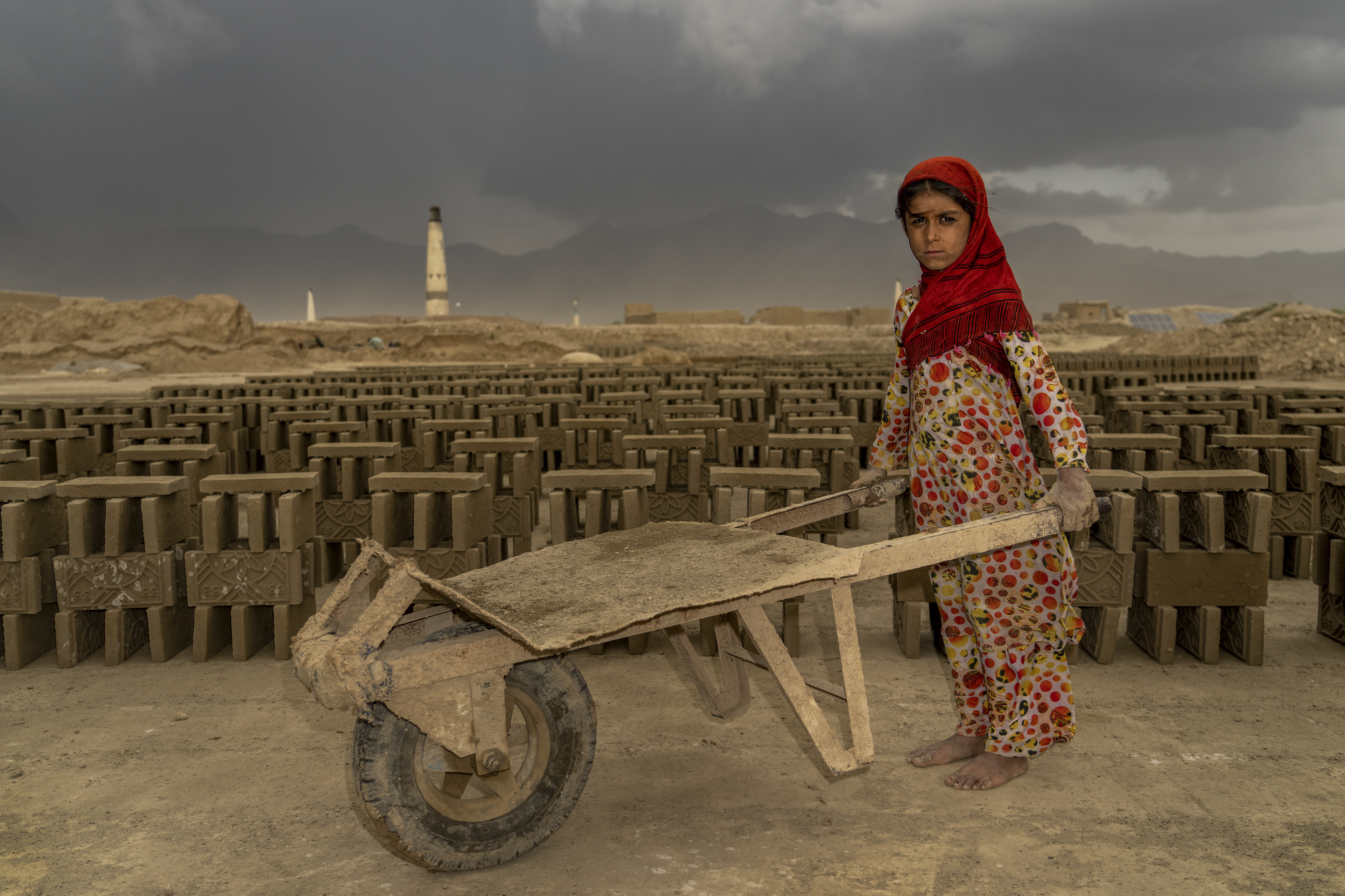 A 9-year-old Afghan girl works in a brick factory on the outskirts of Kabul.