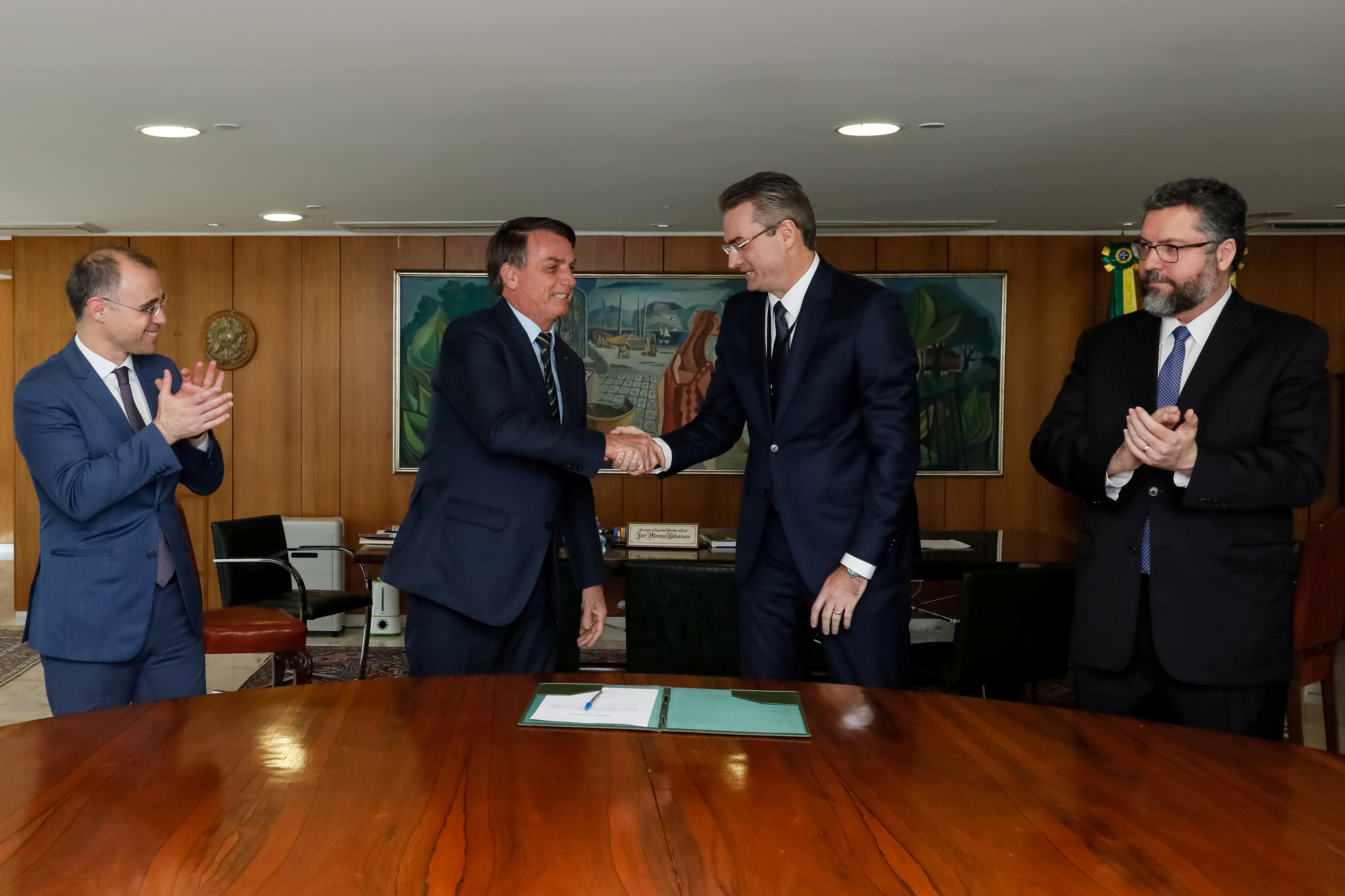 El presidente se da la mano con el jefe de la policía federal Rolando Alexandre de Souza, junto al ministro de Justicia Andre Luiz de Almeida Mendonca y el ministro de Exteriores Ernesto Araujo, el 4 de mayo pasado Isac Nobrega/Brazilian Presidency/Handout via REUTERS