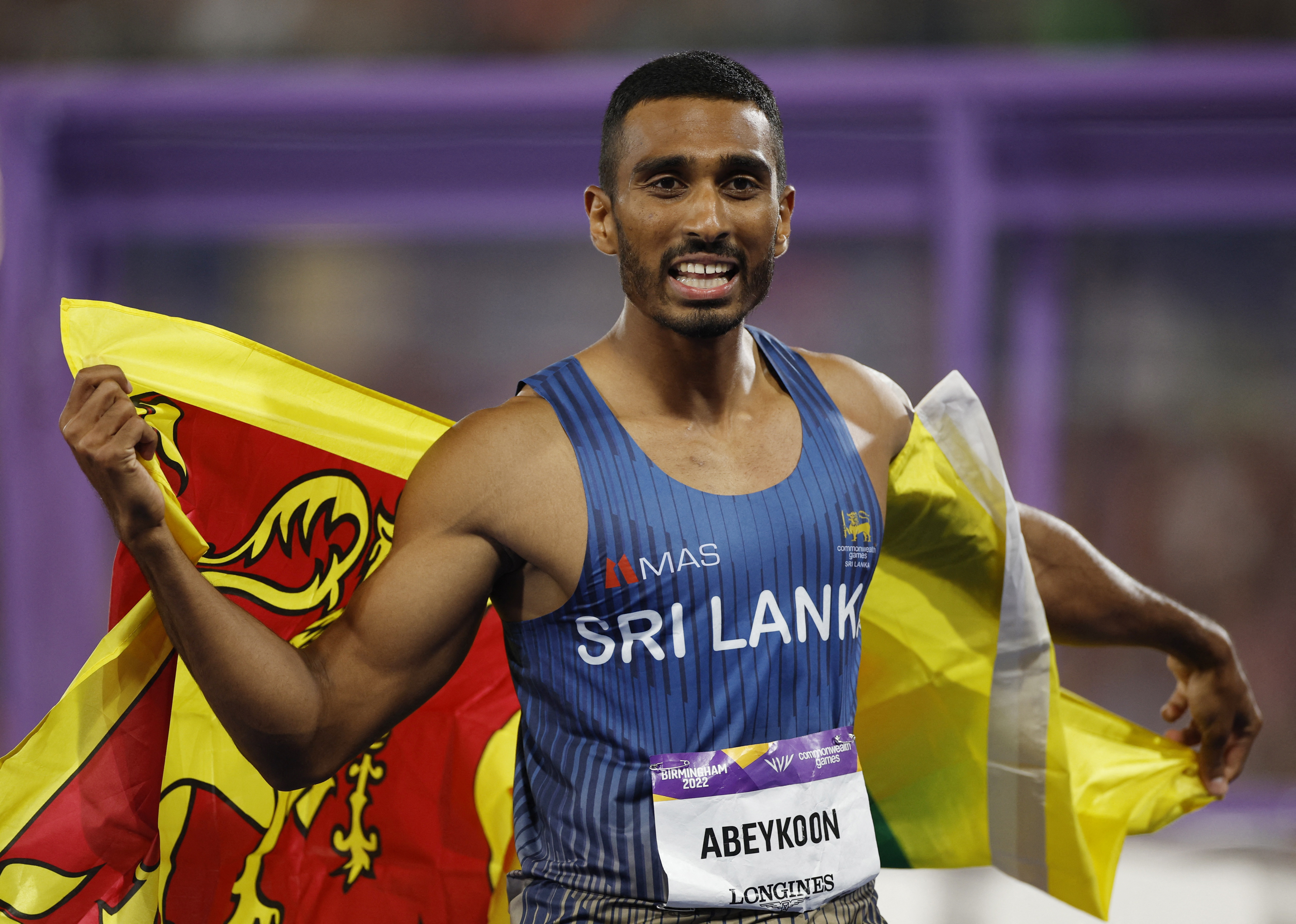 Commonwealth Games - Athletics - Men's 100m - Final - Alexander Stadium, Birmingham, Britain - August 3, 2022 Sri Lanka's Yupun Abeykoon celebrates after winning bronze REUTERS/John Sibley