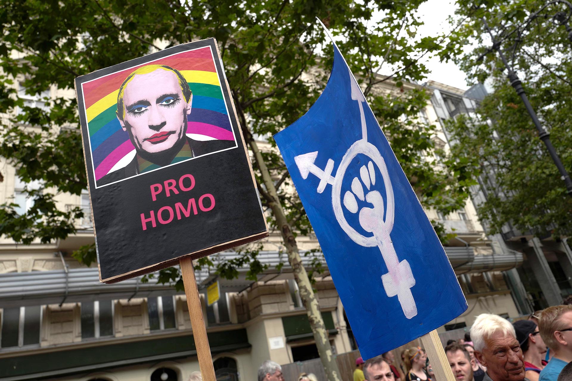 Un participante sostiene una pancarta con una imagen del presidente ruso Vladimir Putin con maquillaje durante el desfile anual del Orgullo en Berlín el 22 de julio de 2017