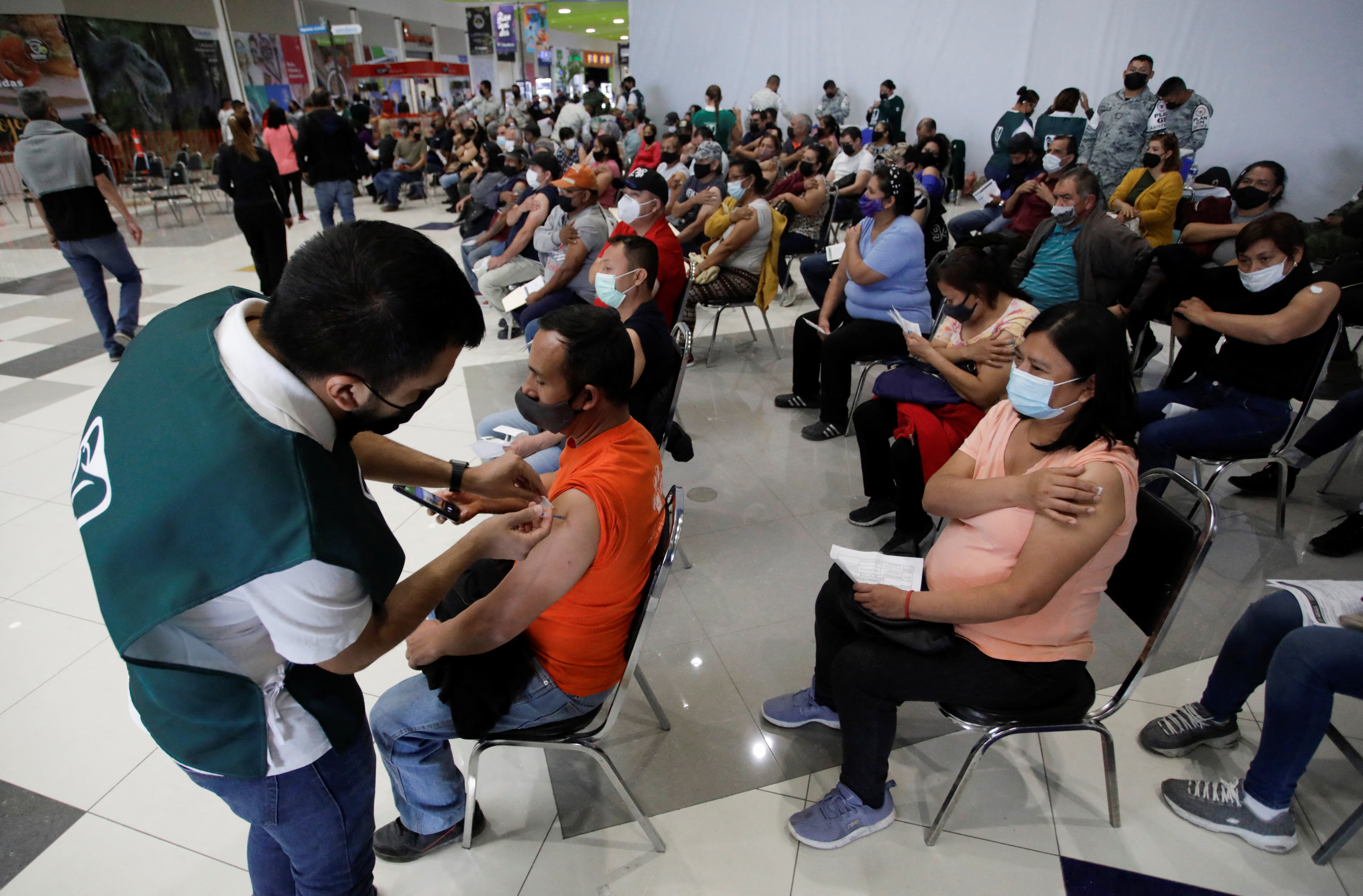 A man receives a booster dose of the AstraZeneca coronavirus disease (COVID-19) vaccine, in Santa Catarina, on the outskirts of Monterrey, Mexico January 19, 2022. REUTERS/Daniel Becerril