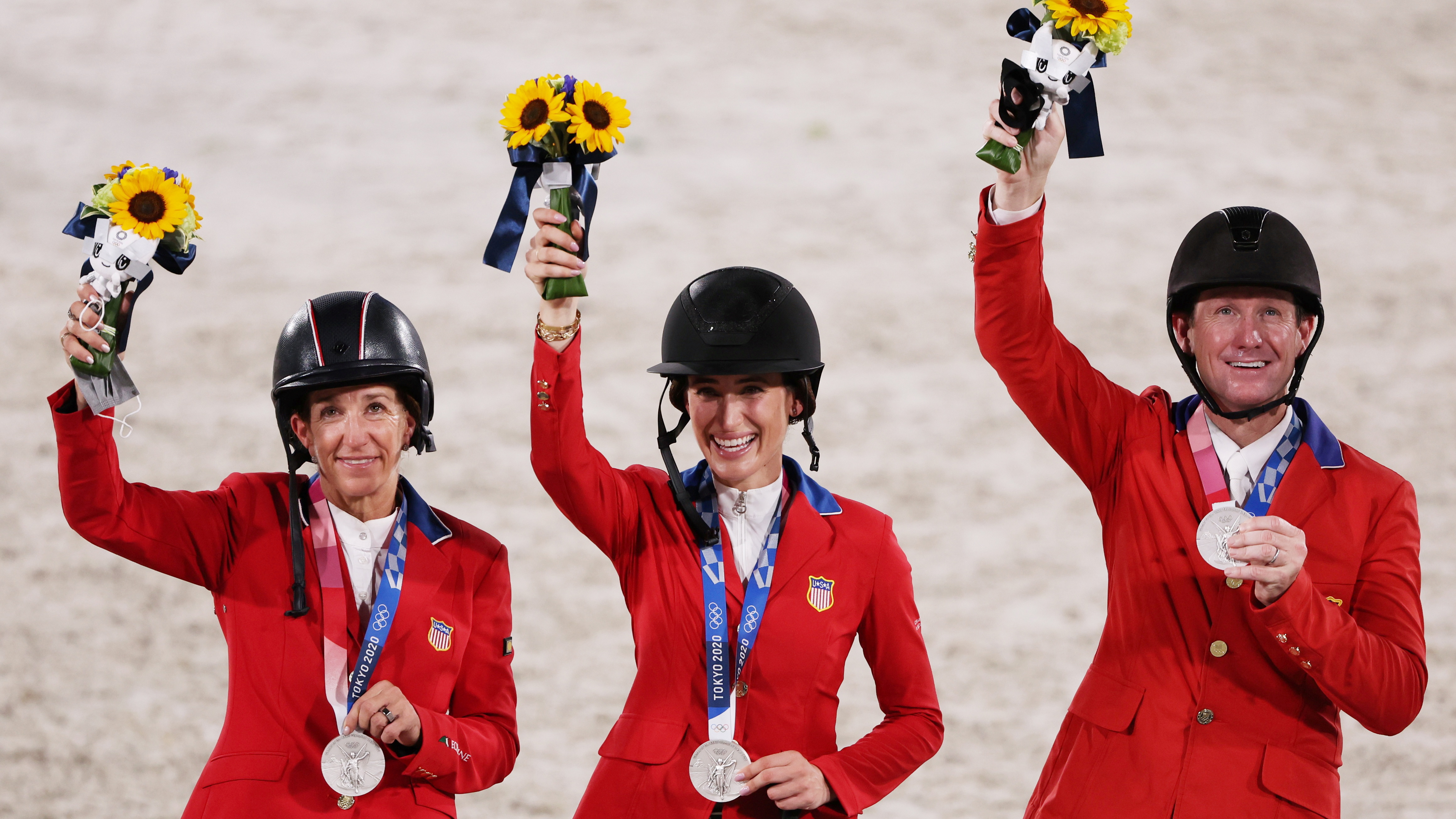 Tokyo 2020 Olympics - Equestrian - Jumping - Team - Medal Ceremony - Equestrian Park - Tokyo, Japan - August 7, 2021. Silver medallists Laura Kraut of the United States, Jessica Springsteen of the United States and McLain Ward of the United States celebrate. REUTERS/Alkis Konstantinidis
