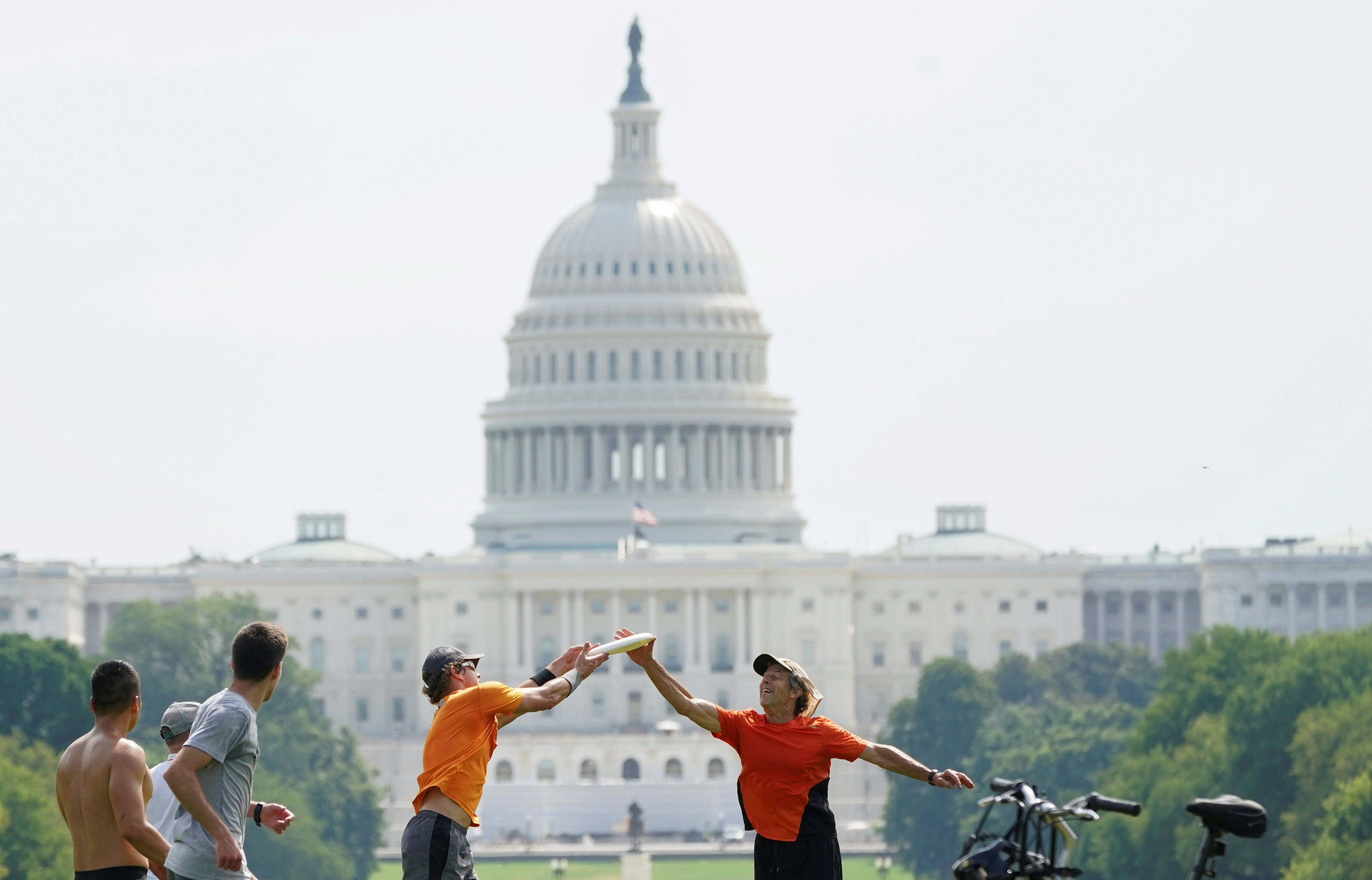 With the U.S. Capitol in the background, players battle for possession during a game of ultimate frisbee on the National Mall during a heat wave in Washington, U.S., July 20, 2020.  REUTERS/Kevin Lamarque     TPX IMAGES OF THE DAY