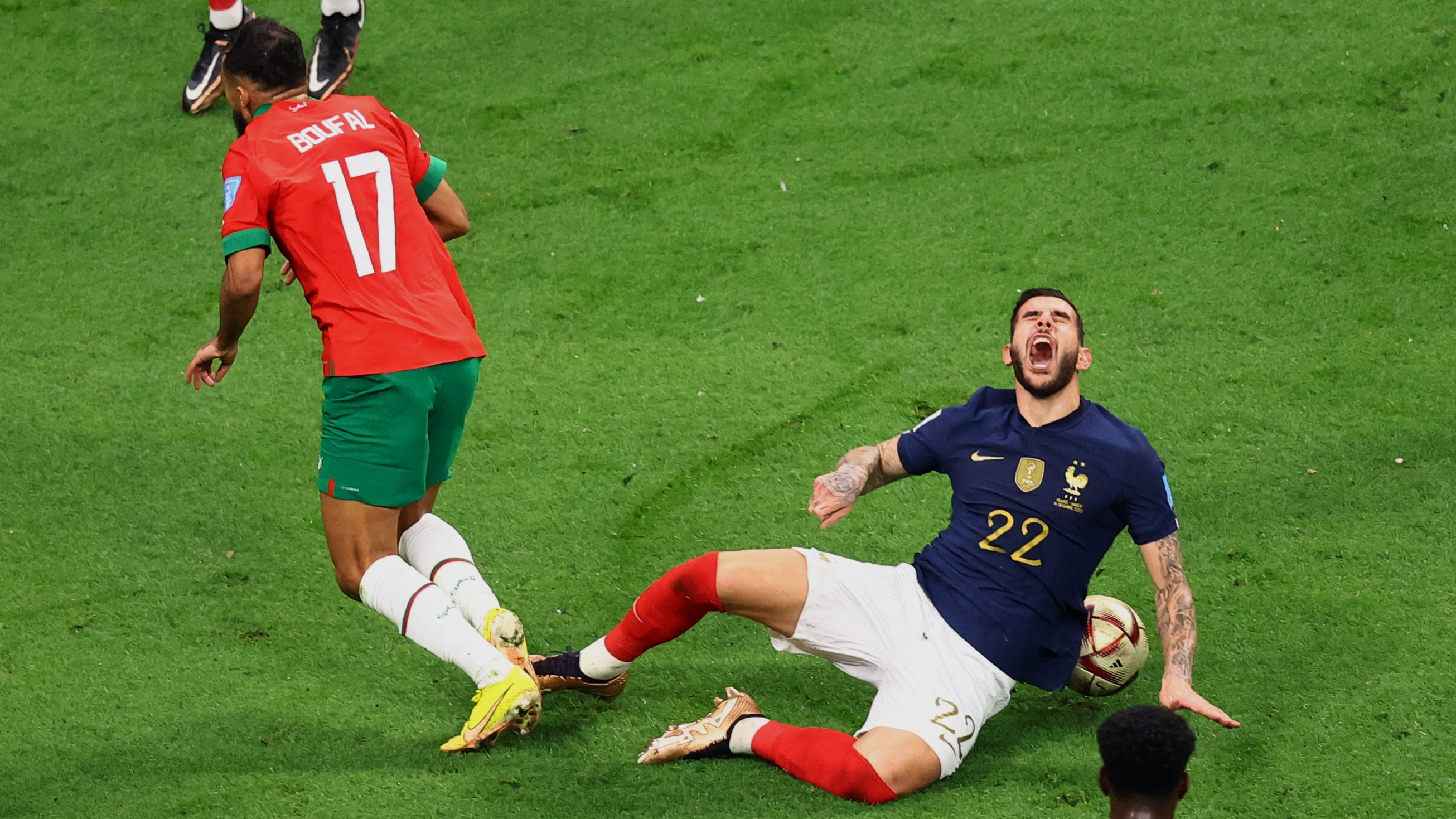 Soccer Football - FIFA World Cup Qatar 2022 - Semi Final - France v Morocco - Al Bayt Stadium, Al Khor, Qatar - December 14, 2022 Morocco's Sofiane Boufal in action with France's Theo Hernandez REUTERS/Hannah Mckay