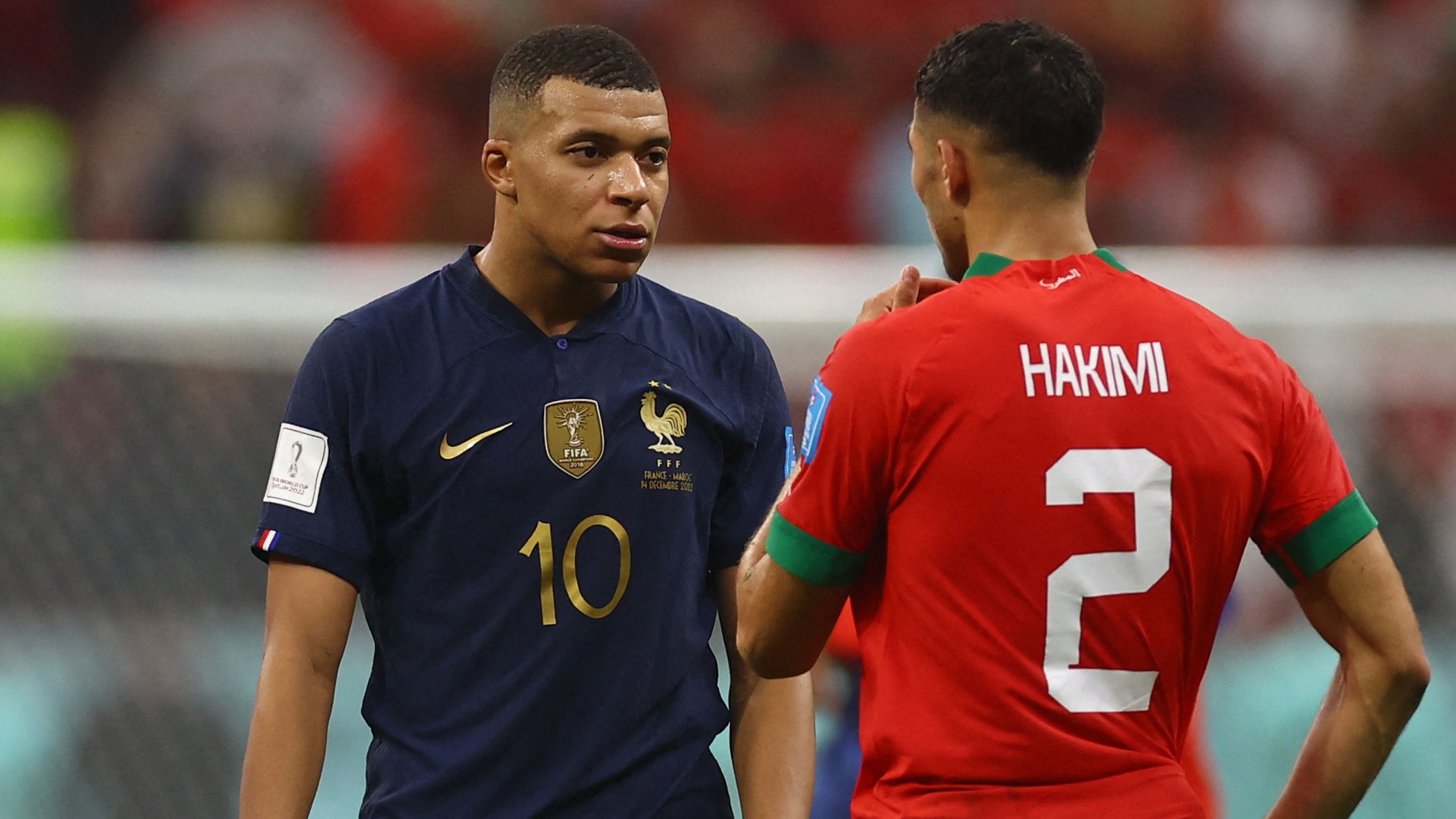 Soccer Football - FIFA World Cup Qatar 2022 - Semi Final - France v Morocco - Al Bayt Stadium, Al Khor, Qatar - December 14, 2022 France's Kylian Mbappe speaks with Morocco's Achraf Hakimi after the match REUTERS/Kai Pfaffenbach