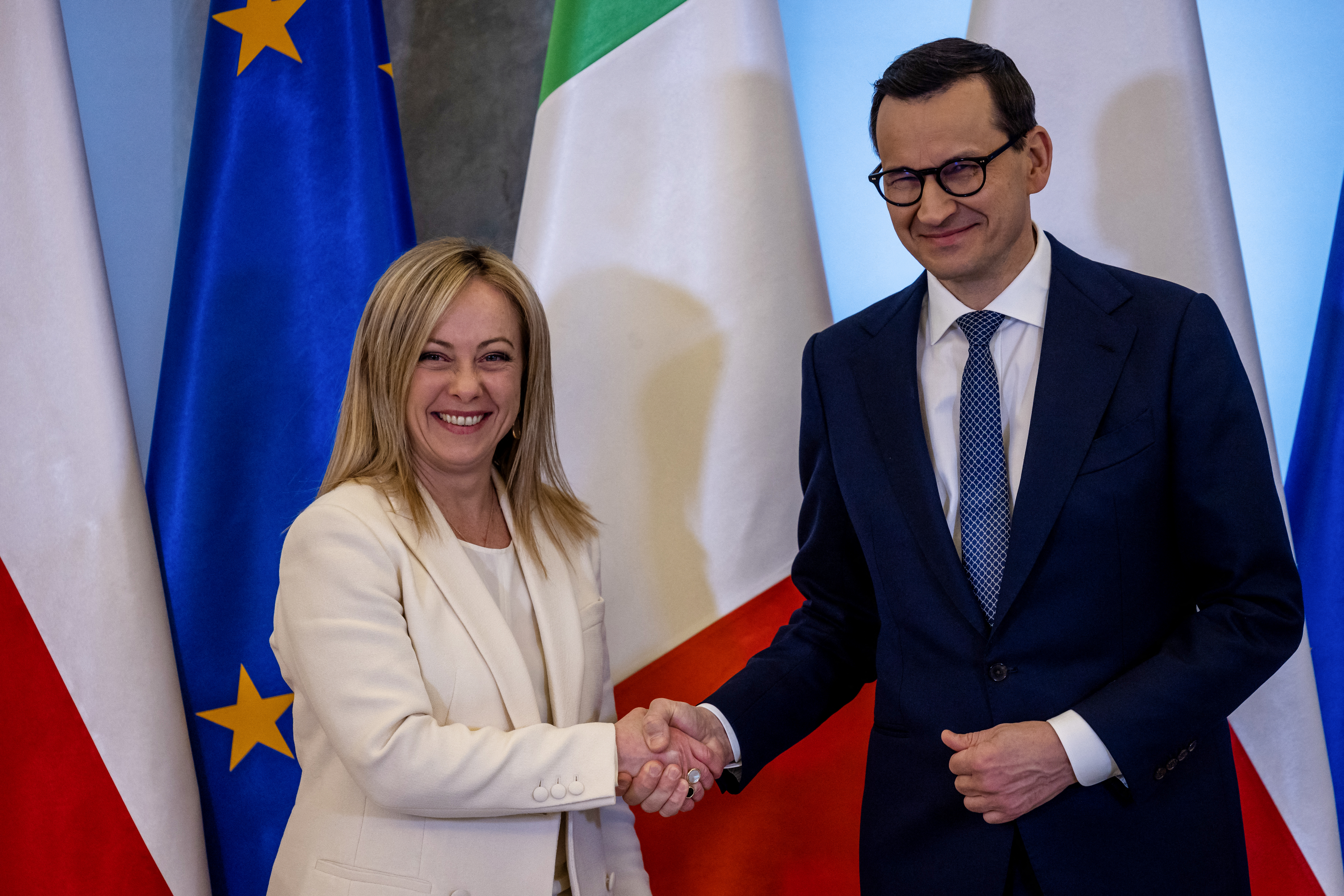 Meloni estrecha la mano del primer ministro polaco Mateusz Morawiecki (Wojtek RADWANSKI / AFP)