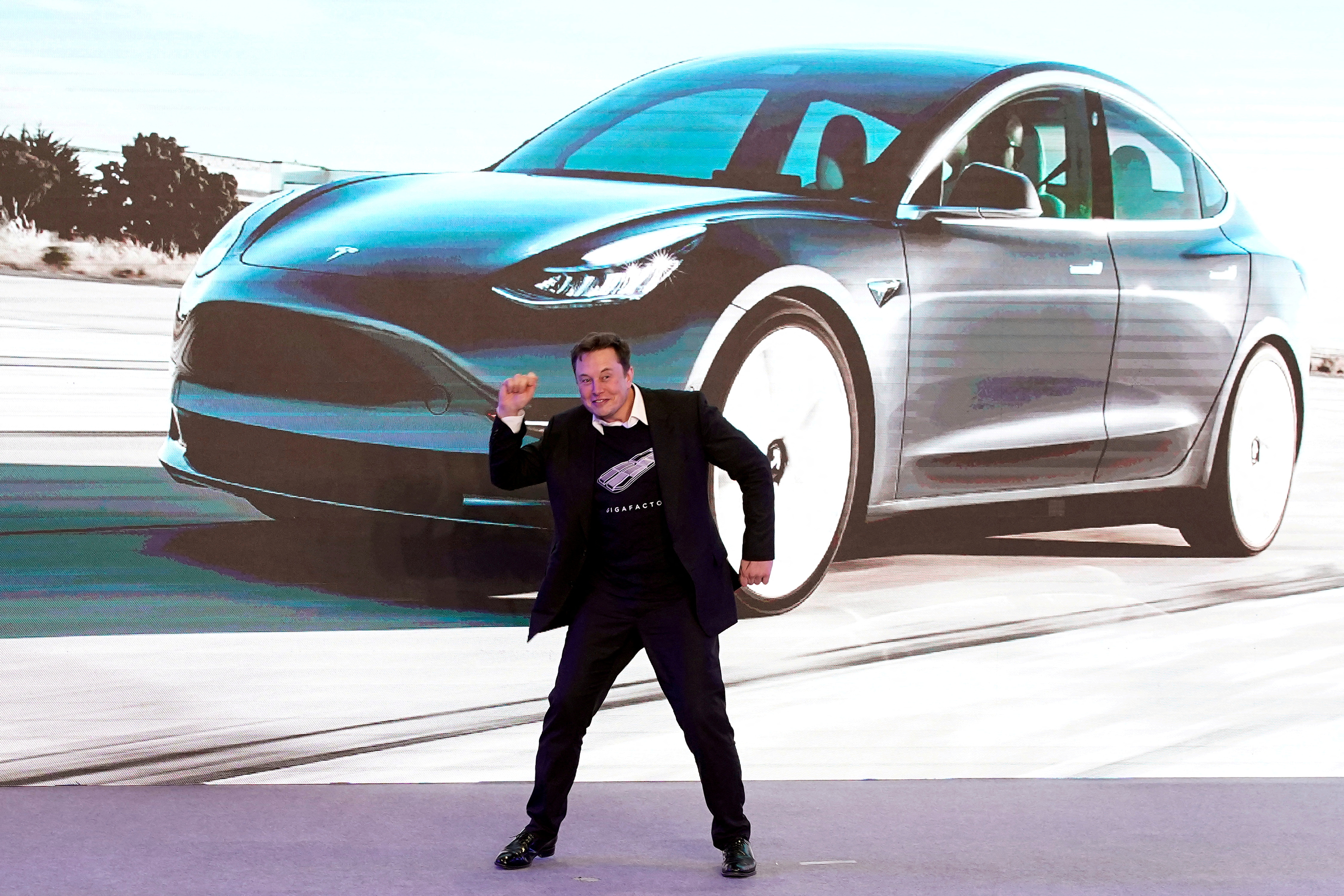 Elon Musk dances at a Tesla show in China, January 2020 (Reuters)
