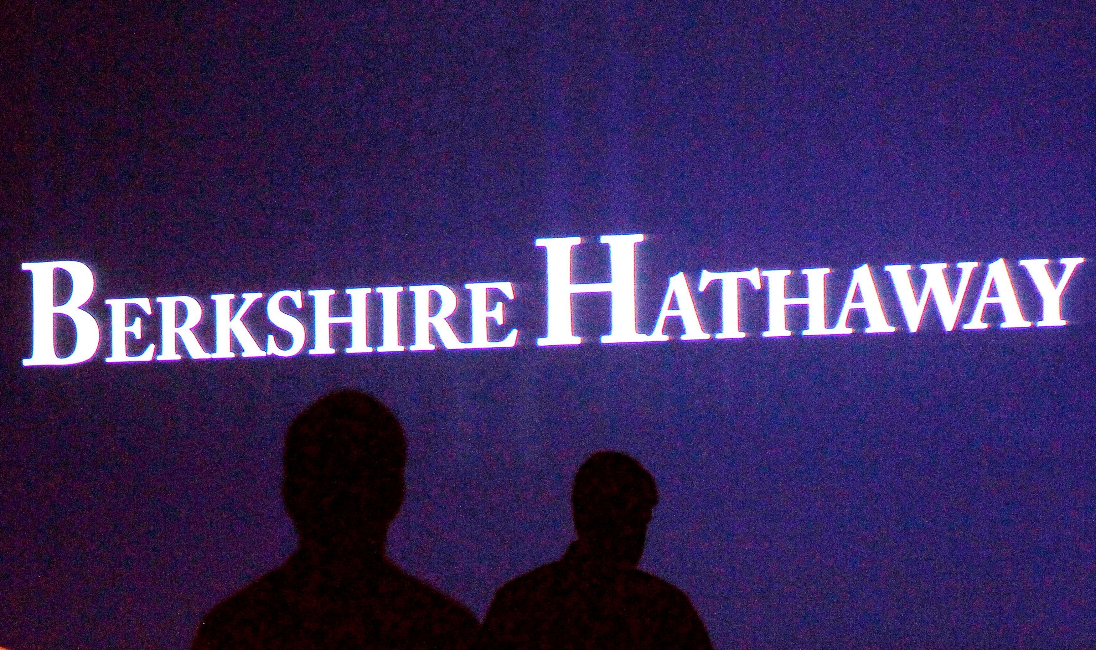 FILE PHOTO: Berkshire Hathaway shareholders walk in front of a video screen at the company's annual meeting in Omaha on May 4, 2013. REUTERS/Rick Wilking