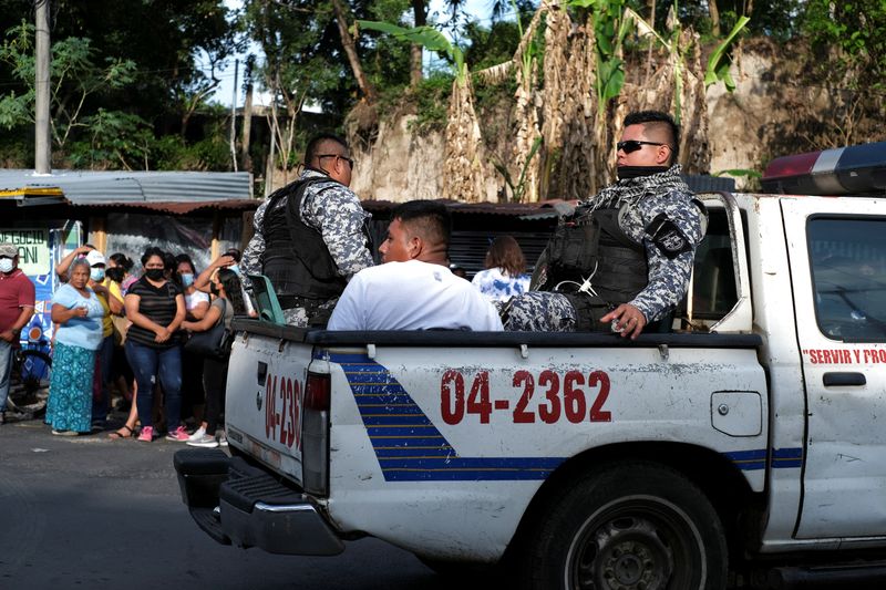 Policías escoltan a un hombre detenido durante el estado de emergencia en El Salvador