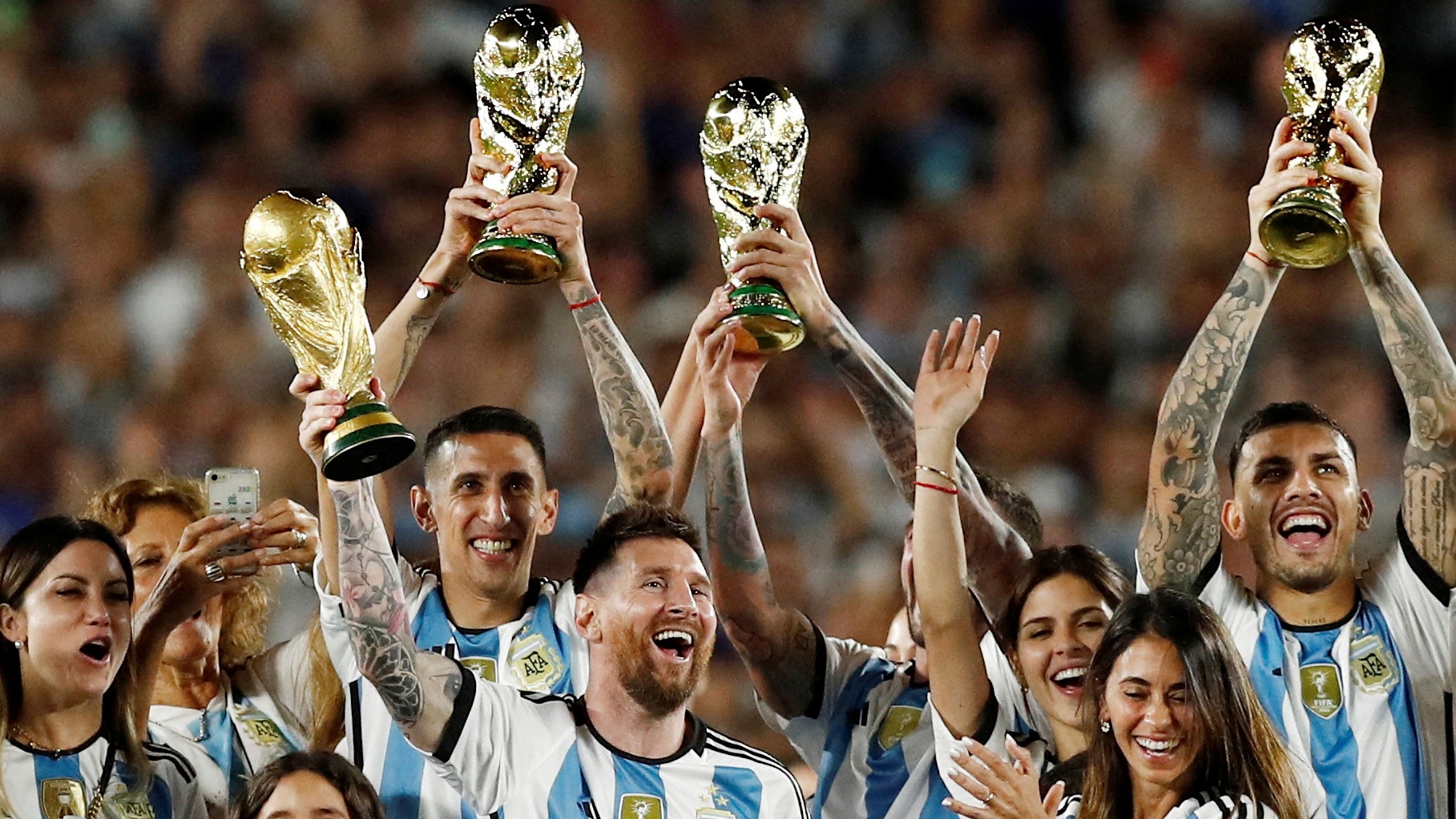 Soccer Football - International Friendly - Argentina v Panama - Estadio Monumental, Buenos Aires, Argentina - March 23, 2023 Argentina's Lionel Messi and teammates celebrate with their families and World Cup trophies after the match REUTERS/Agustin Marcarian     TPX IMAGES OF THE DAY
