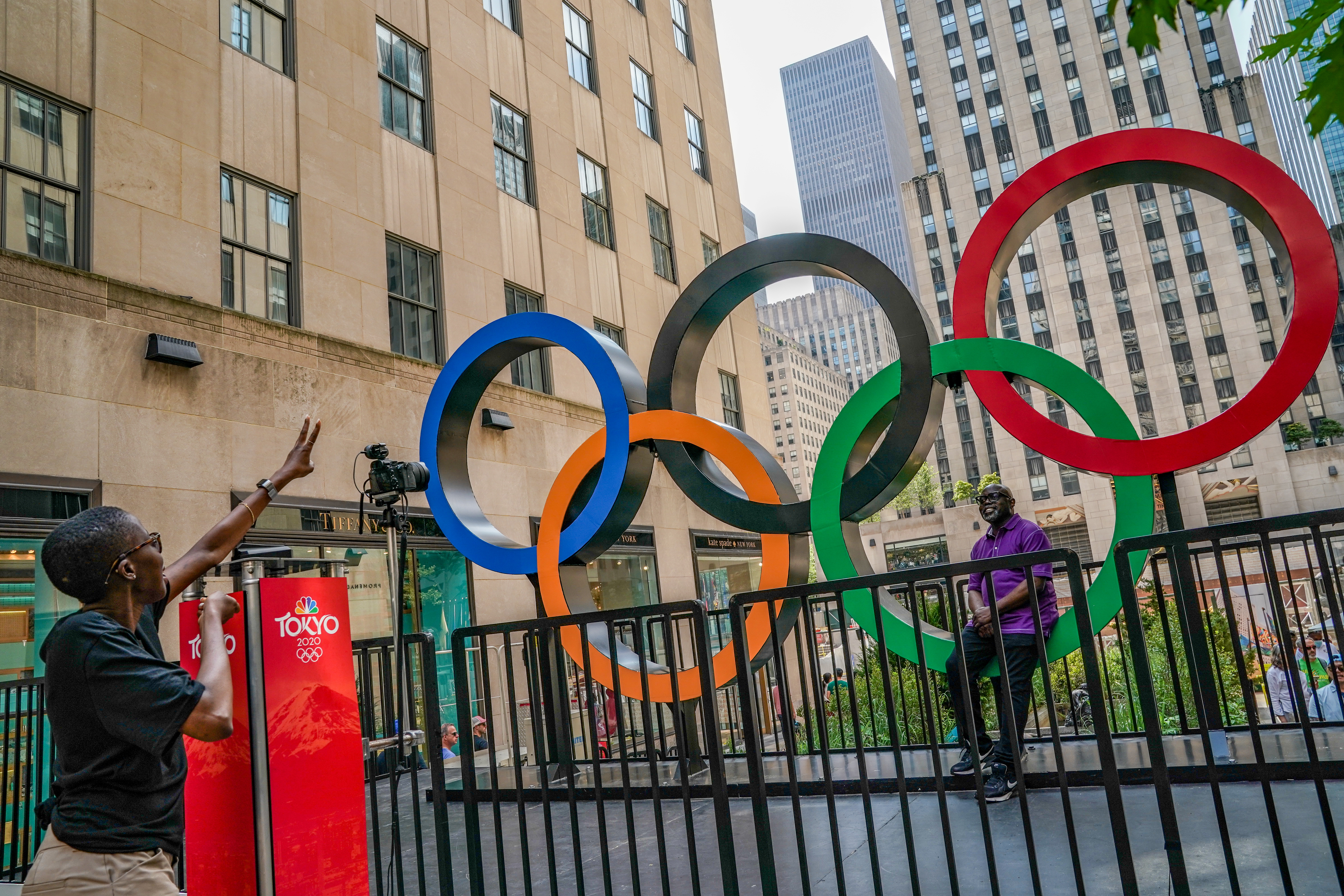 A person has their photo taken at an Olympic Rings installation at the Channel Gardens Rockefeller Center in New York City, U.S., July 24, 2021.  REUTERS/David 'Dee' Delgado