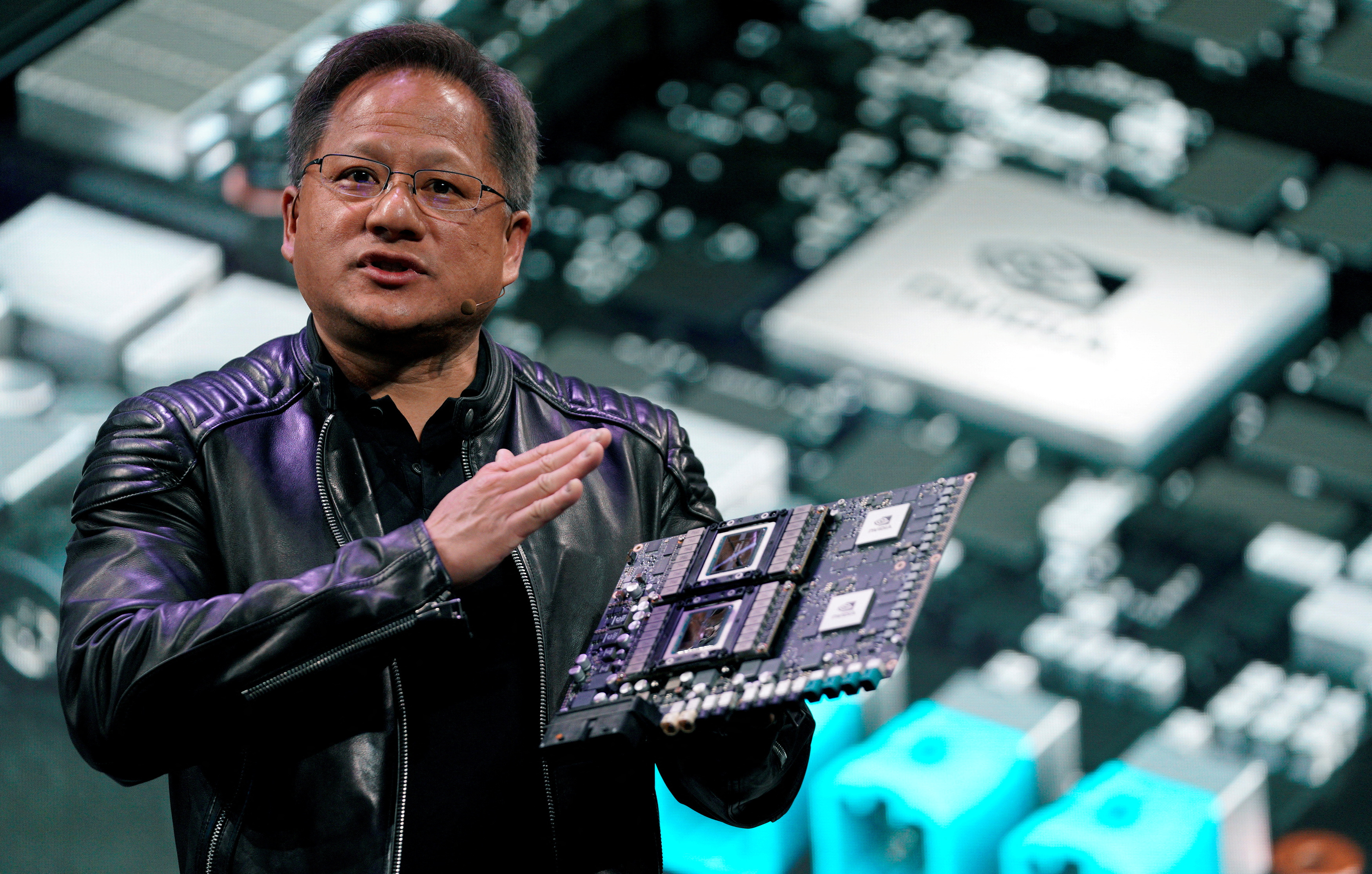 Jensen Huang, CEO of Nvidia, shows off the Drive Pegasus robotaxi AI computer.  REUTERS/Rick Wilking/File Photo