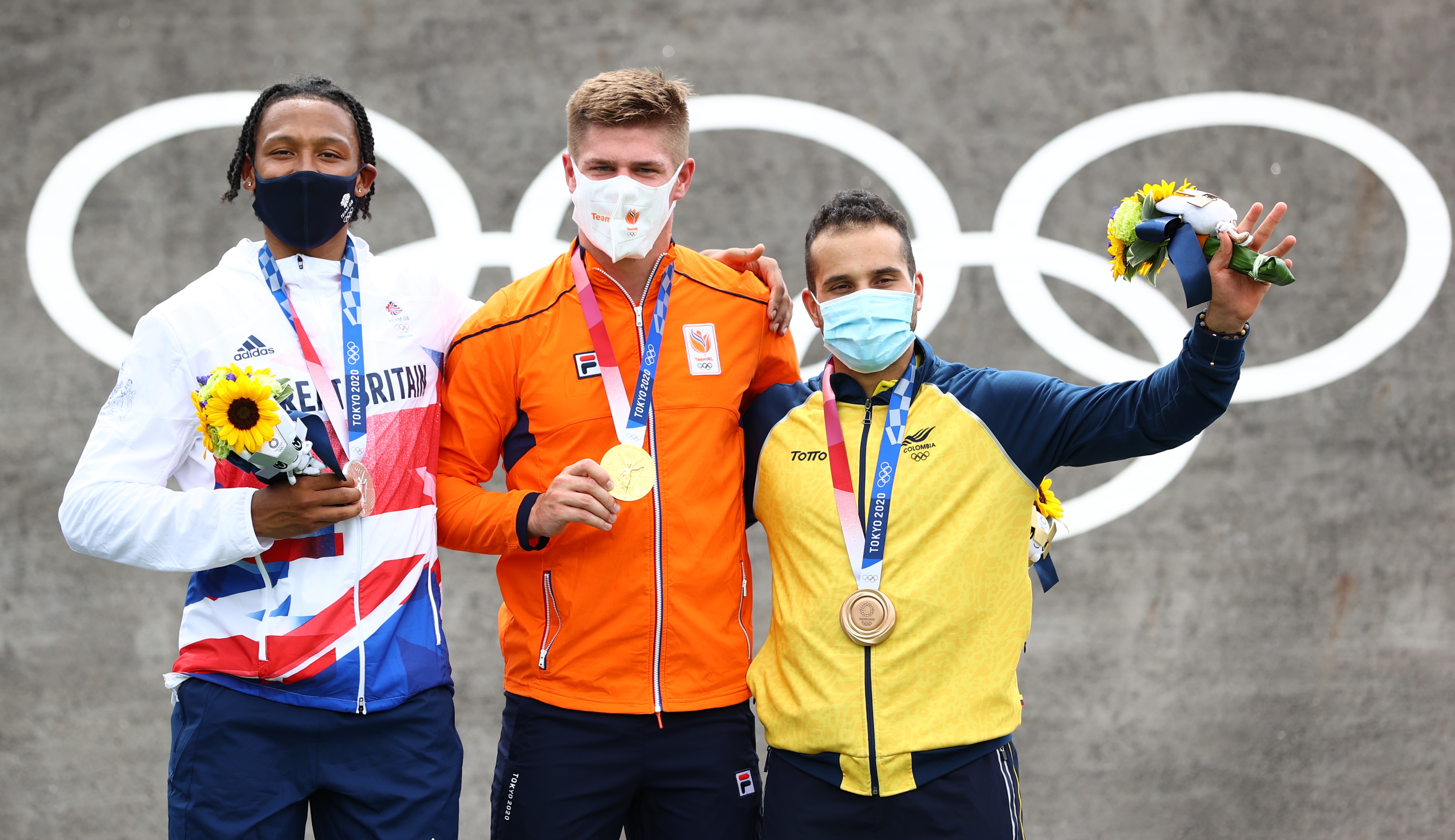 Tokyo 2020 Olympics - BMX Racing - Men's Individual - Medal Ceremony - AUP - Ariake Urban Sports Park, Tokyo, Japan - July 30, 2021. Gold medallist Niek Kimmann of the Netherlands celebrates with silver medallist, Kye Whyte of Britain and bronze medallist, Carlos Ramirez of Colombia. REUTERS/Matthew Childs