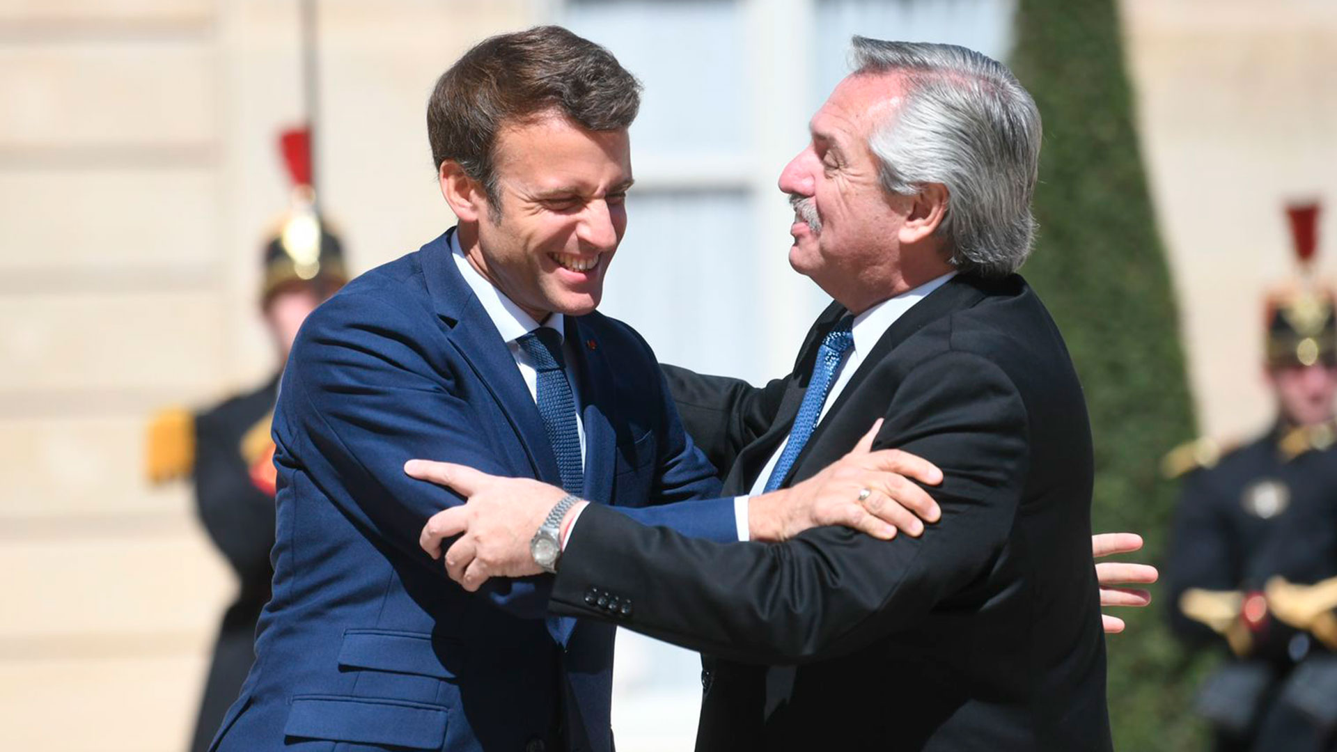 Emmanuel Macron hugs Alberto Fernández prior to the meeting they held in Paris