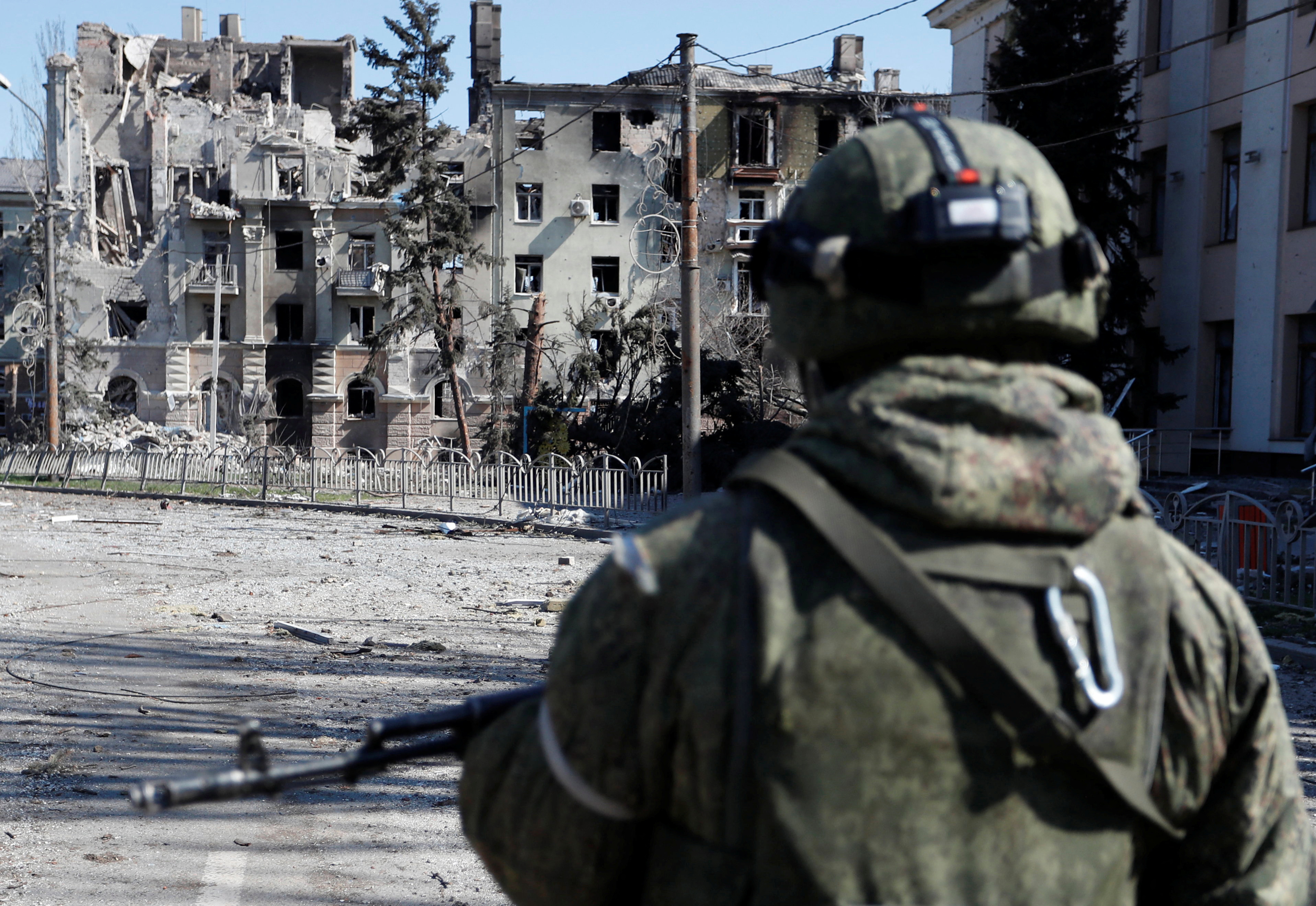 Service members of pro-Russian troops inspect streets of Mariupol