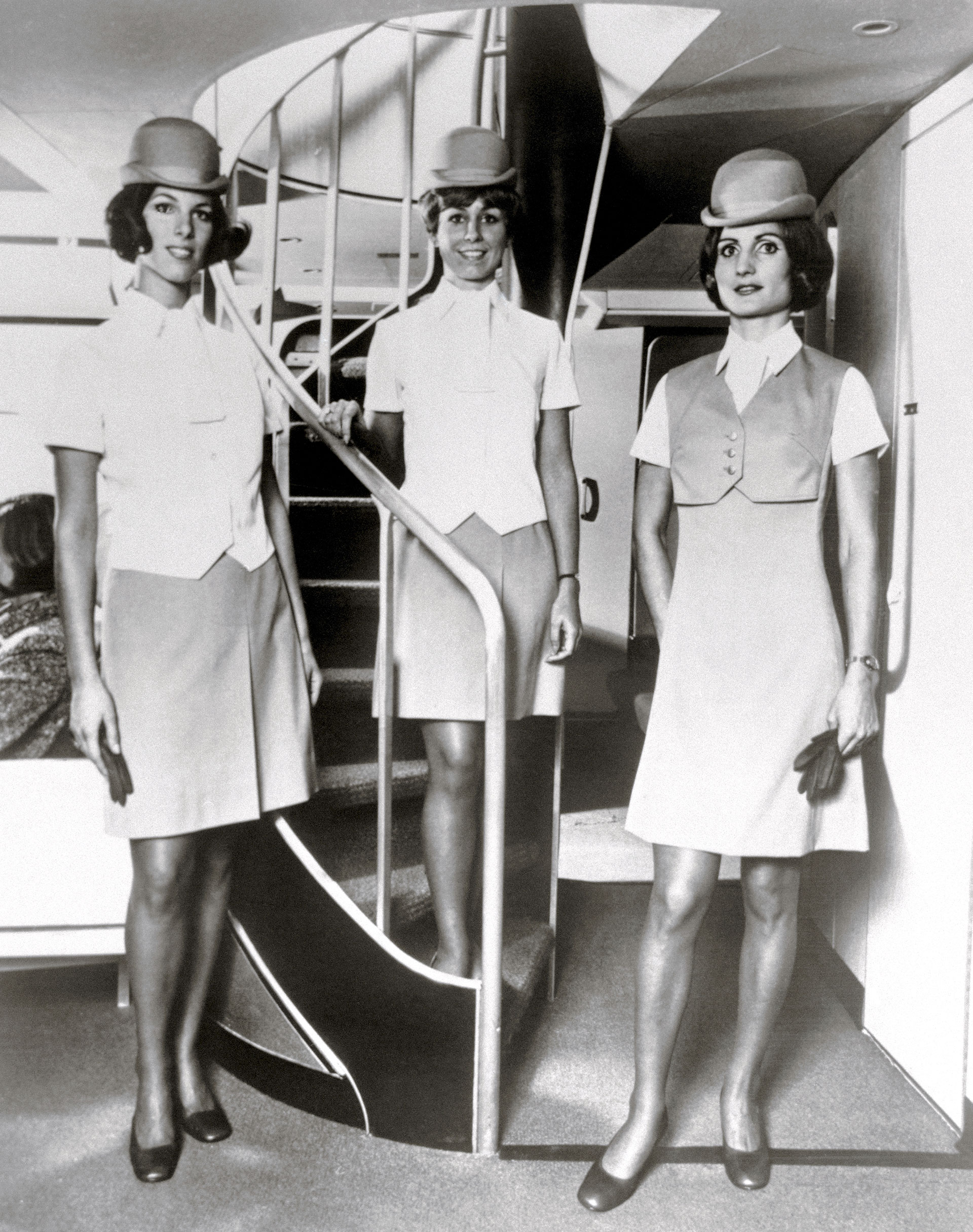 Flight attendants pose in their uniforms on the stairs aboard the new Boeing Pan Am 747 transport plane (Bettmann)