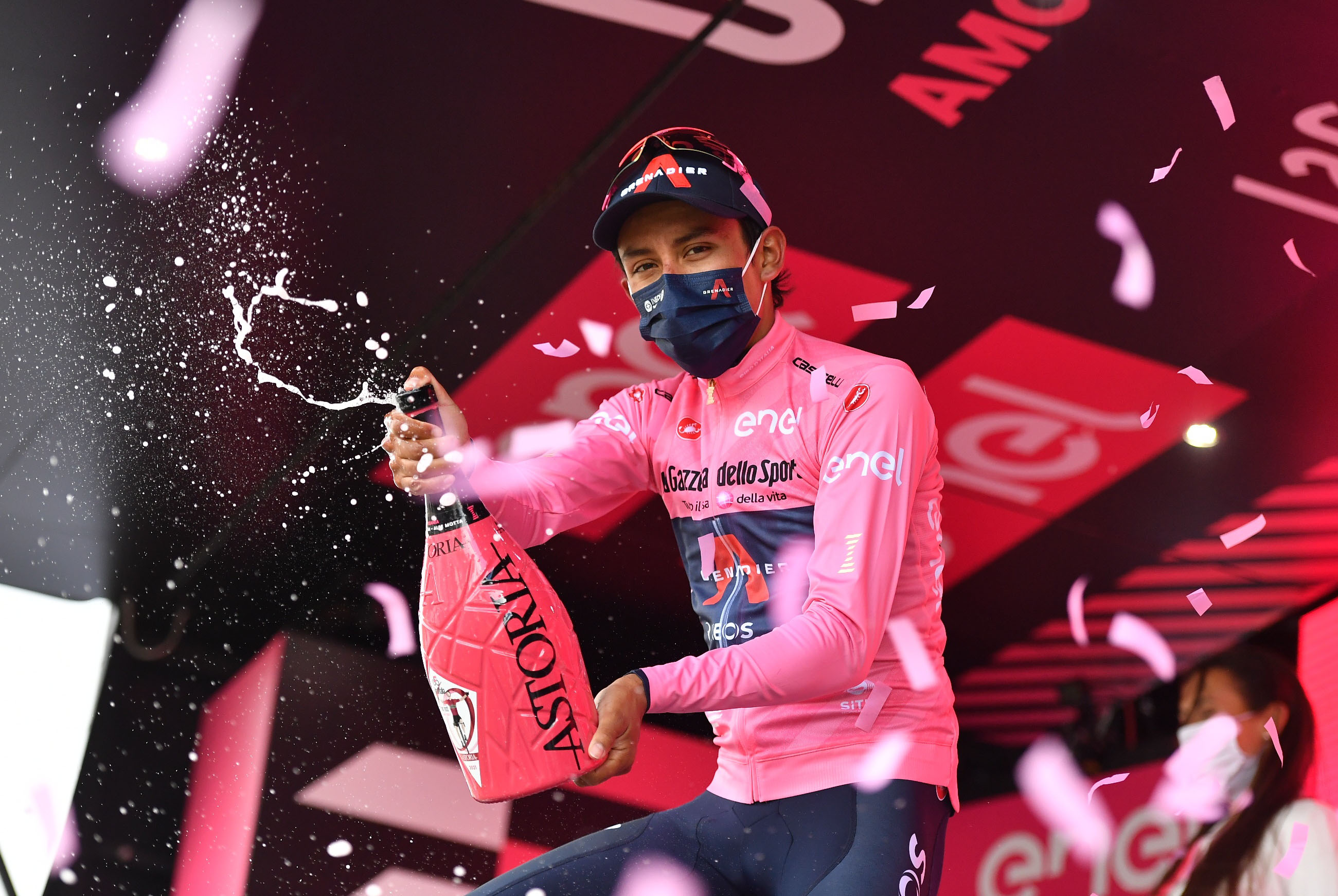 Cycling - Giro d'Italia - Stage 20 - Verbania to Valle Spluga-Alpe Motta, Italy - May 29, 2021 Ineos Grenadiers rider Egan Arley Bernal Gomez of Colombia celebrates wearing the maglia rosa with sparkling wine on the podium after stage 20 REUTERS/Jennifer Lorenzini