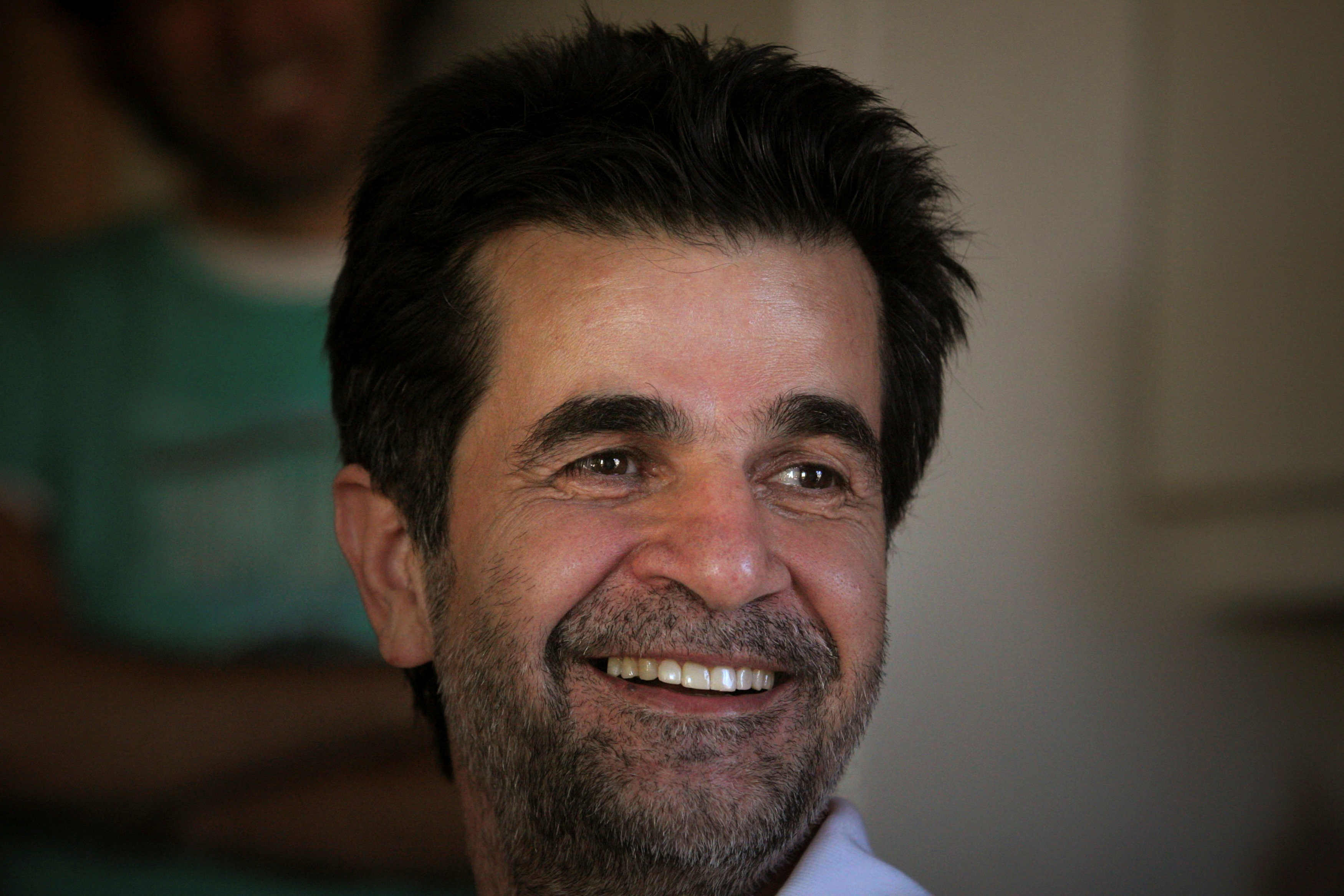 FILE PHOTO: Iranian film director Jafar Panahi smiles, following his release on bail, at his home in Tehran