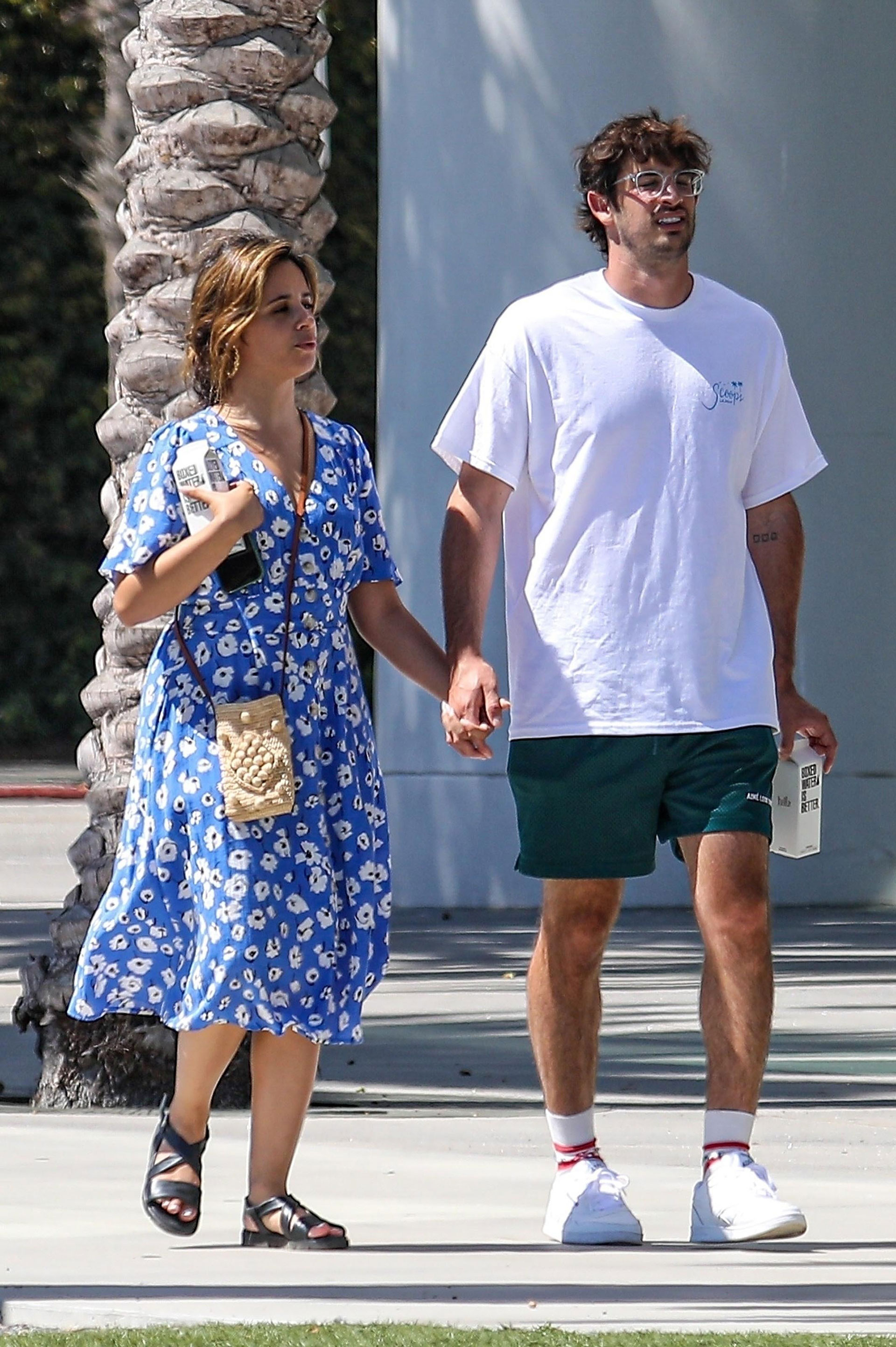 Brand new couple walking the streets of Los Angeles holding hands after breakfast