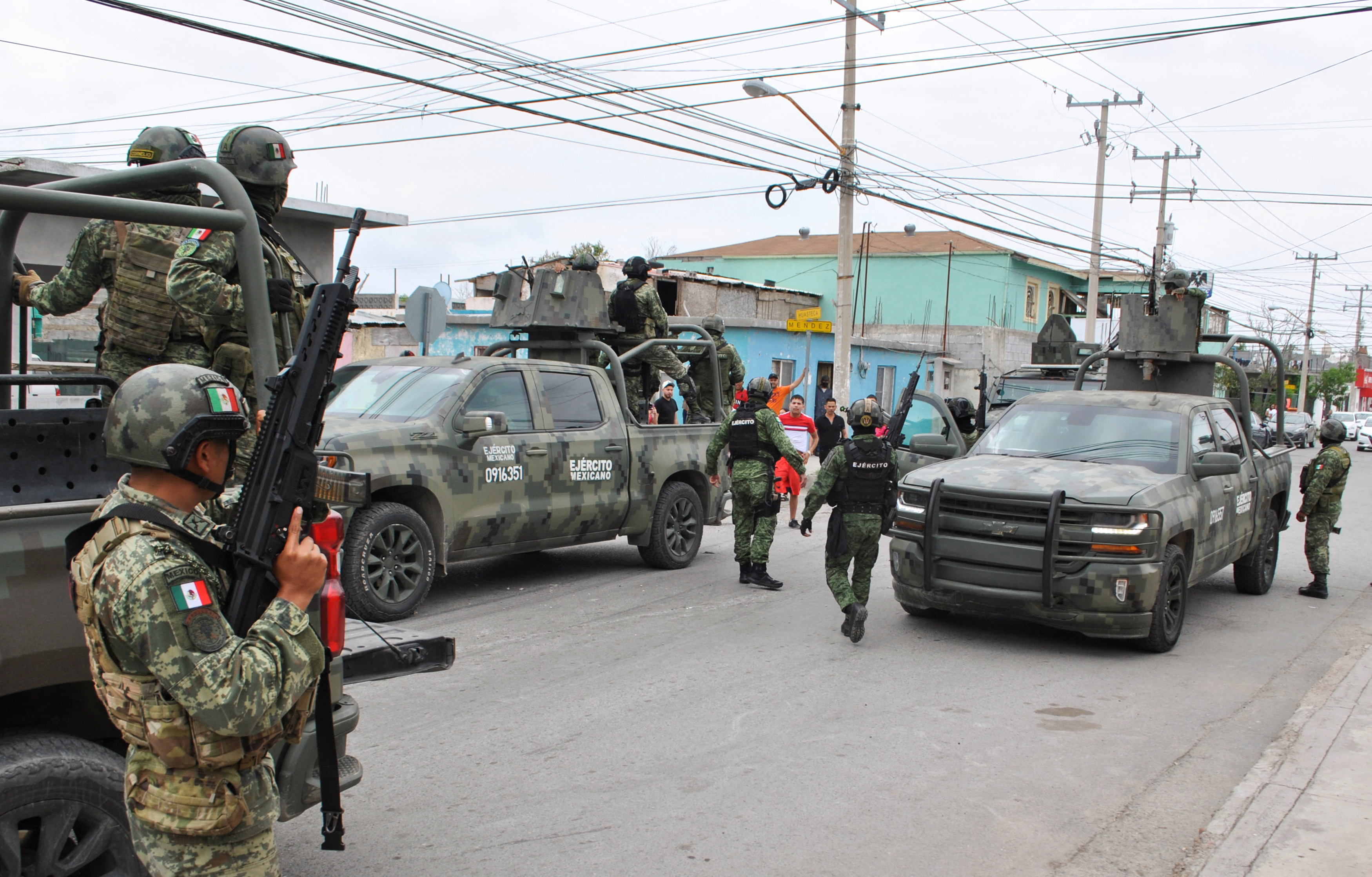 People argue with soldiers near the area where, according to local media, five people were shot dead by Mexican soldiers, in Nuevo Laredo, Mexico February 26, 2023. REUTERS/Jasiel Rubio NO RESALES. NO ARCHIVES