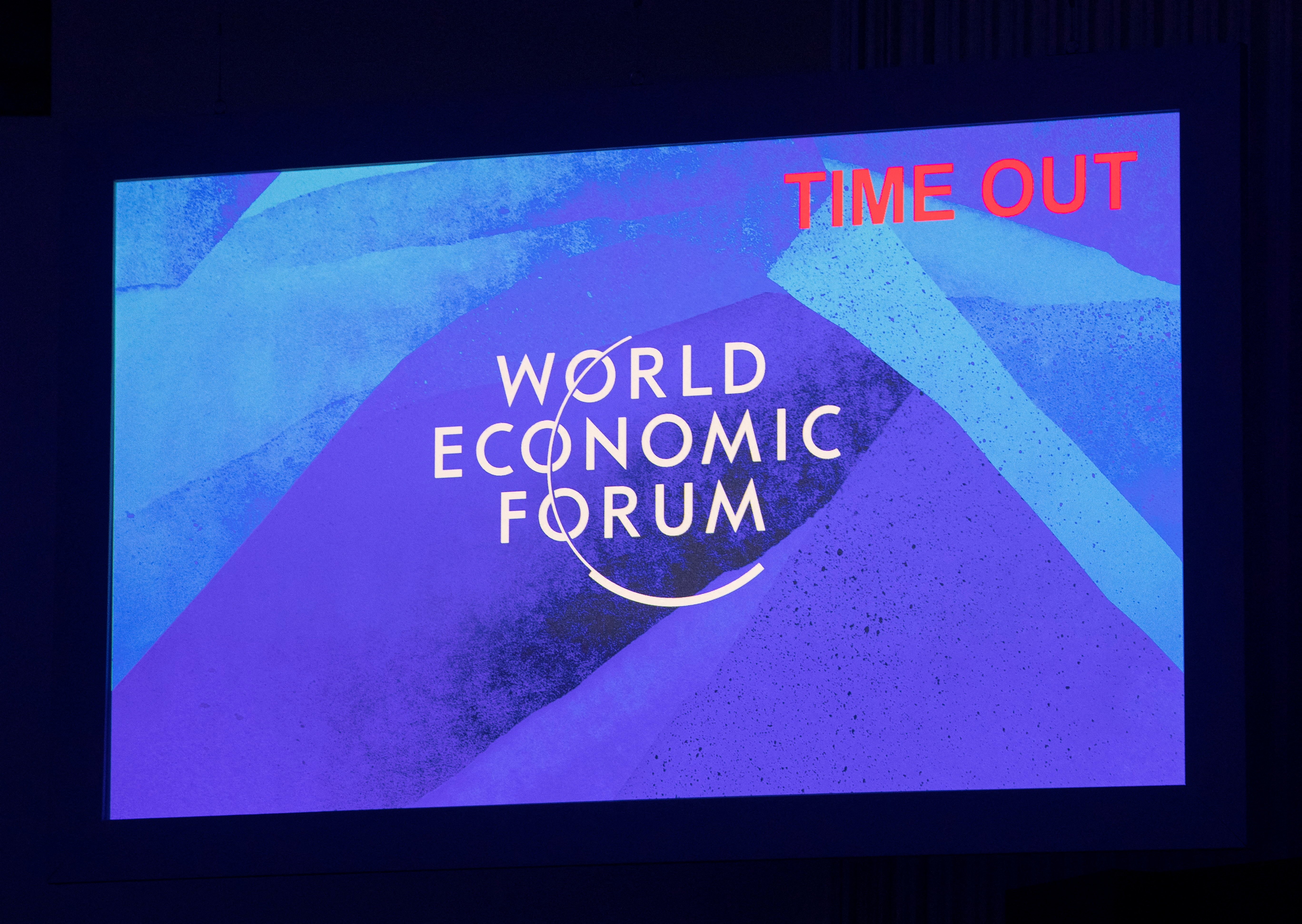 A "Time out" announces the end of a panel discussion on a screen at the World Economic Forum 2022 (WEF) in the Alpine resort of Davos, Switzerland May 23, 2022.  REUTERS/Arnd Wiegmann