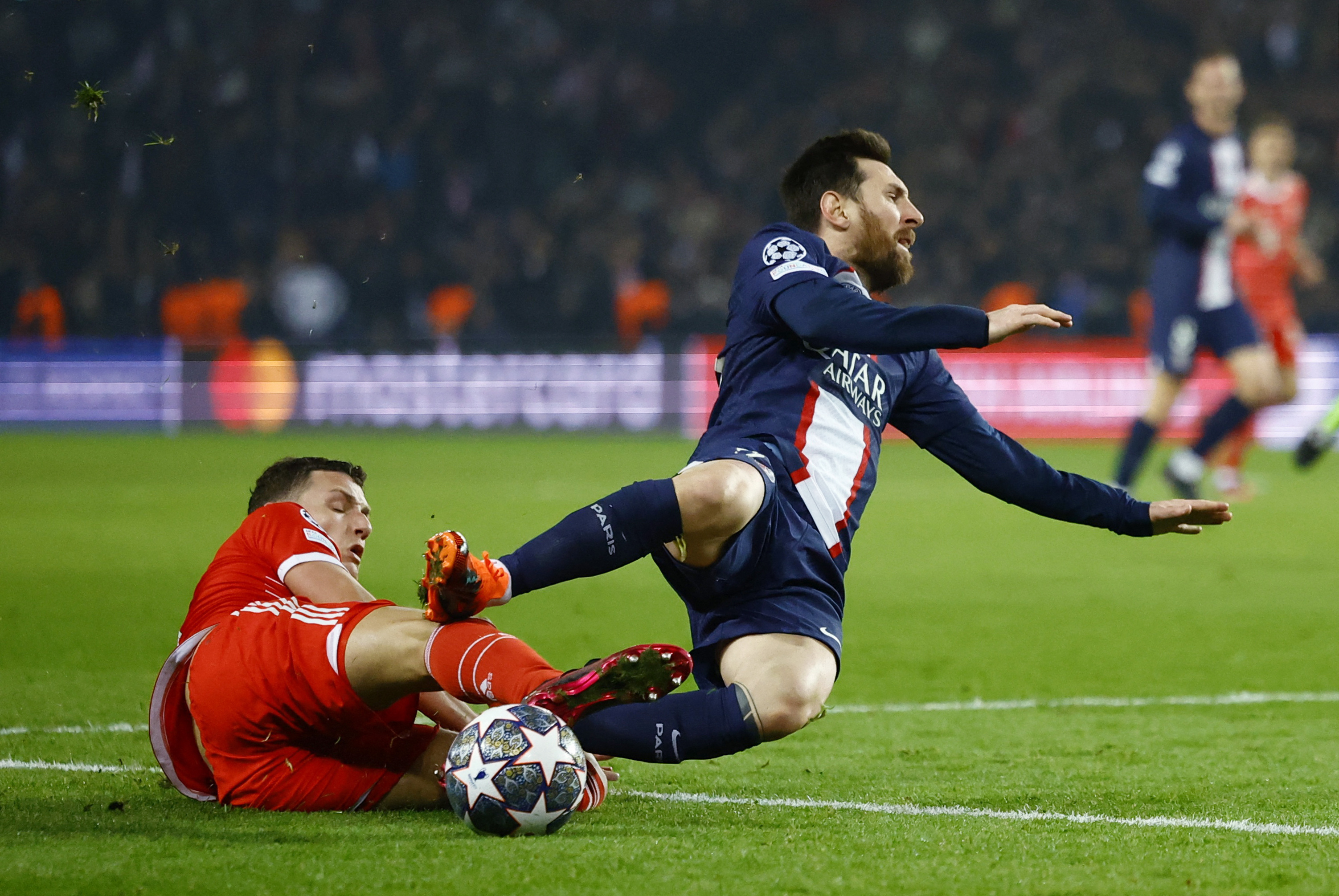 Soccer Football - Champions League - Round of 16 First Leg - Paris St Germain v Bayern Munich - Parc des Princes, Paris, France - February 14, 2023  Bayern Munich's Benjamin Pavard fouls Paris St Germain's Lionel Messi leading to a second yellow card and being sent off REUTERS/Sarah Meyssonnier