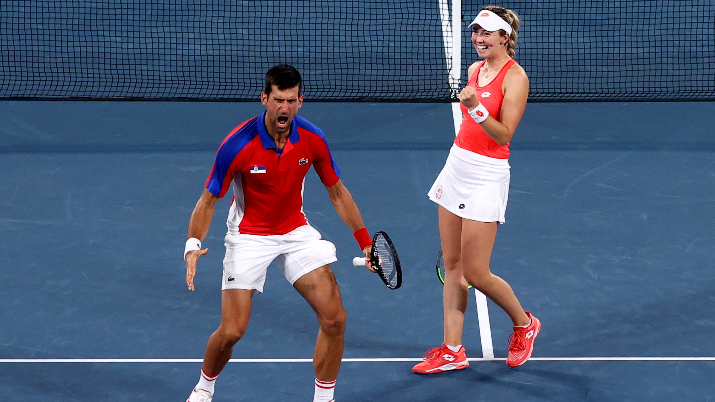 Tokyo 2020 Olympics - Tennis - Mixed Doubles - Round 1 - Ariake Tennis Park - Tokyo, Japan - July 28, 2021. Nina Stojanovic of Serbia and Novak Djokovic of Serbia celebrate after winning their first round match against Luisa Stefani of Brazil and Marcelo Melo of Brazil REUTERS/Edgar Su