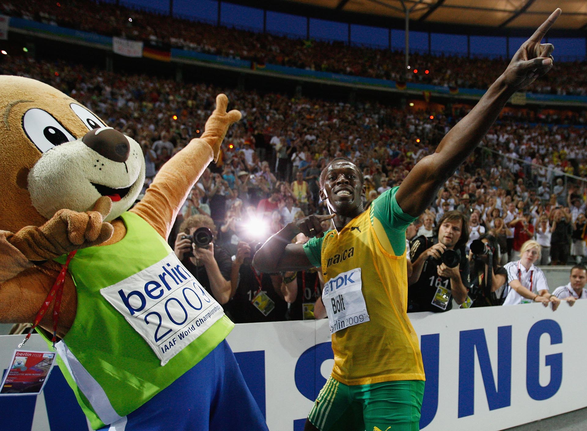 BERLIN - AUGUST 20:  Usain Bolt of Jamaica celebrates winning the gold medal in the men's 200 Metres Final during day six of the 12th IAAF World Athletics Championships at the Olympic Stadium on August 20, 2009 in Berlin, Germany.  Bolt set a new World Record of 19.19 seconds.  (Photo by Andy Lyons/Getty Images)