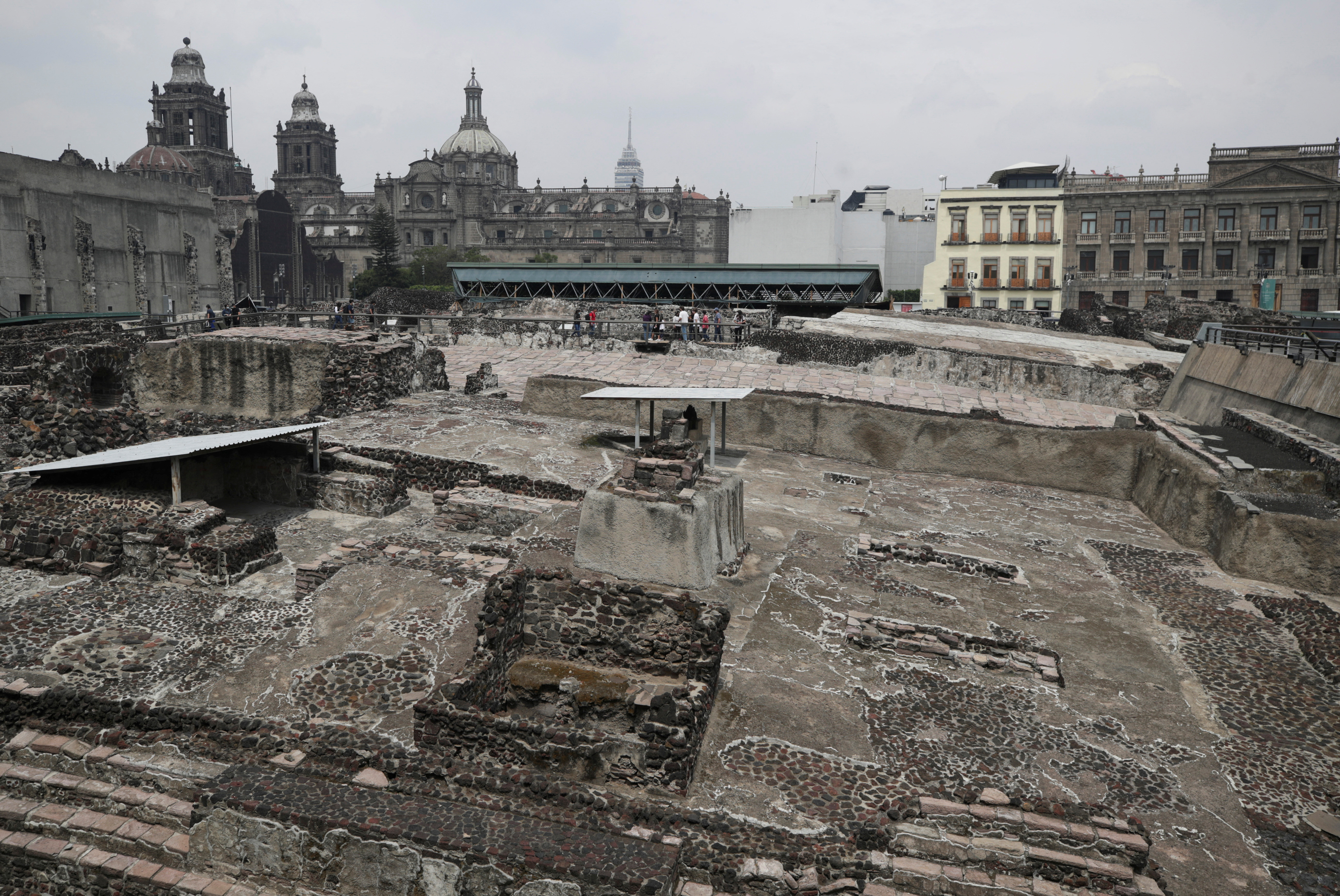 A view shows Aztec ruins at the Templo Mayor, one of Mexico's most important ancient sites, undergoing reconstruction after being damaged in a major storm, in Mexico City, Mexico July 7, 2022. Mexico's Metropolitan Cathedral is pictured in the background. REUTERS/Henry Romero