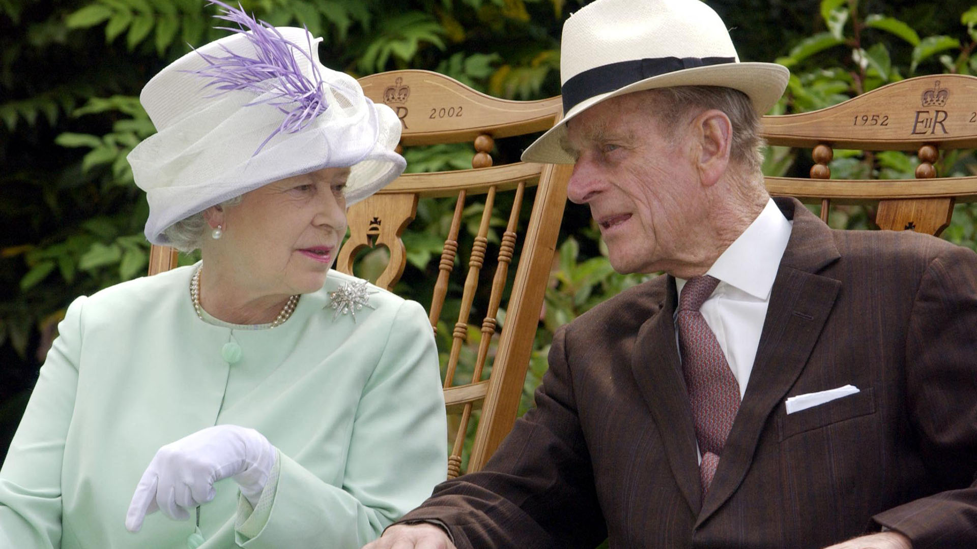 El 17 de julio de 2002, la reina Isabel II y el duque de Edimburgo conversan sentados durante una actuación musical en Abbey Gardens