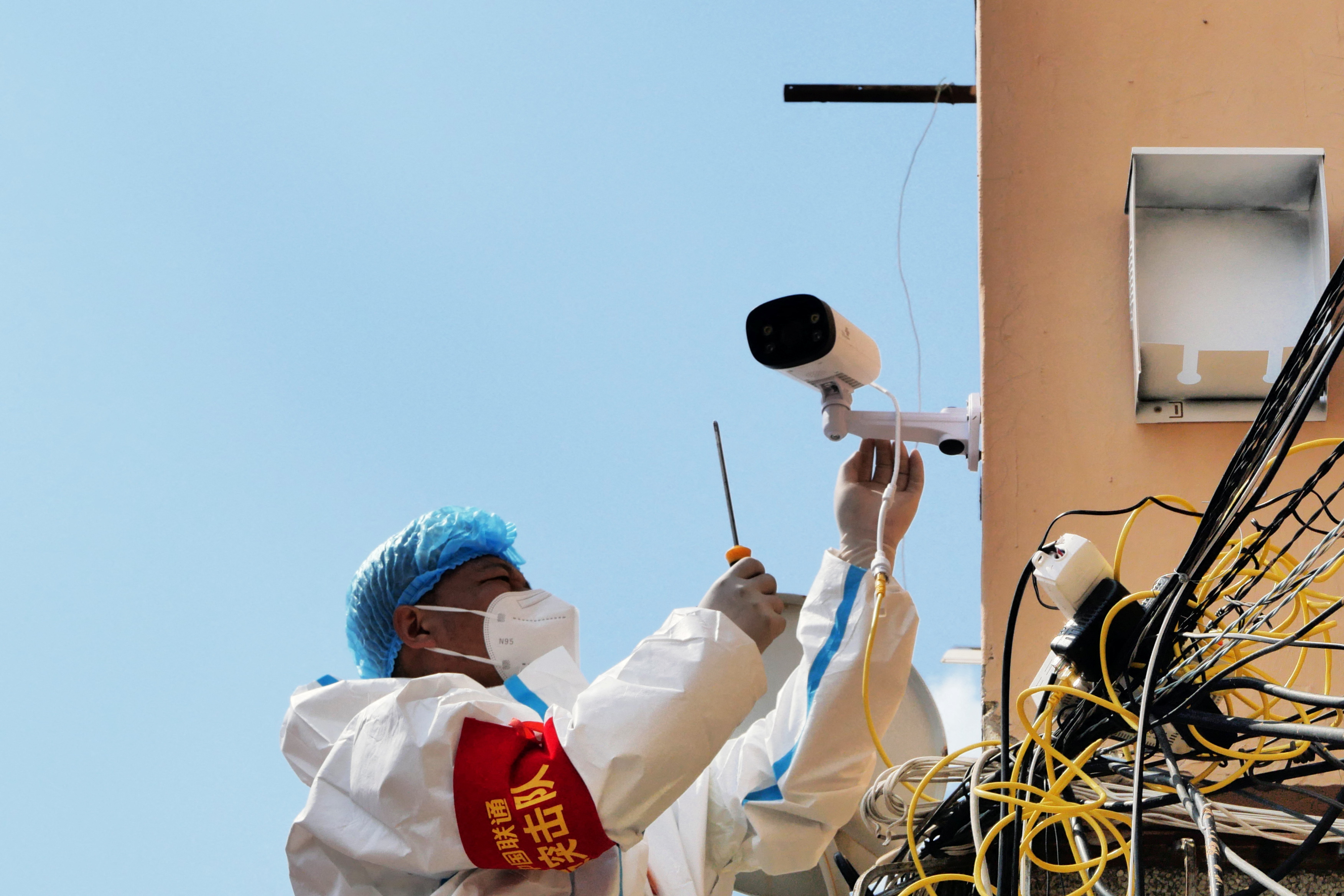 Worker sets up a surveillance camera following COVID-19 cases in Mudanjiang