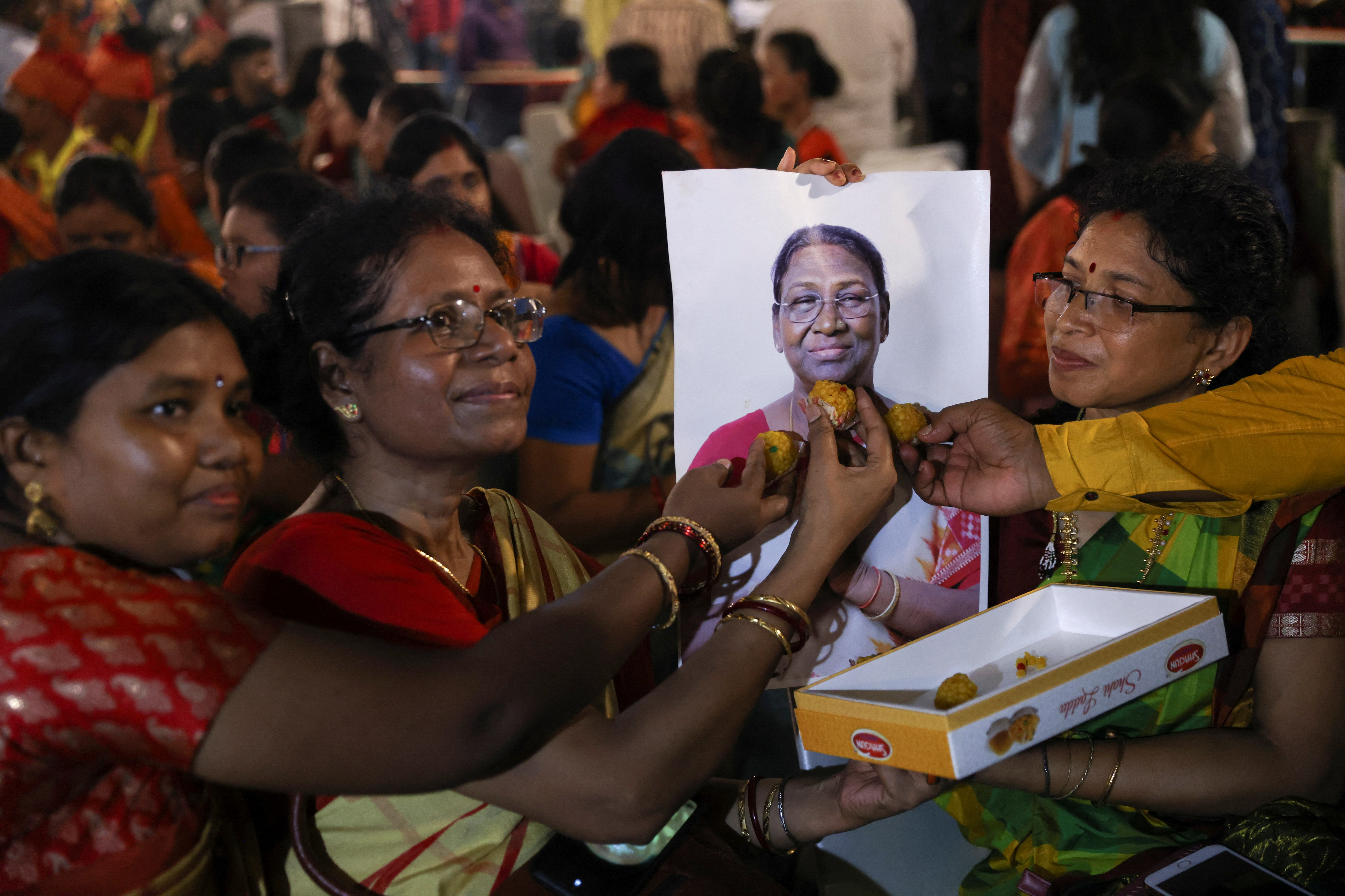 People pose next to a picture of India's President-elect Draupadi Murmu (REUTERS / Aushree Fadnavis)