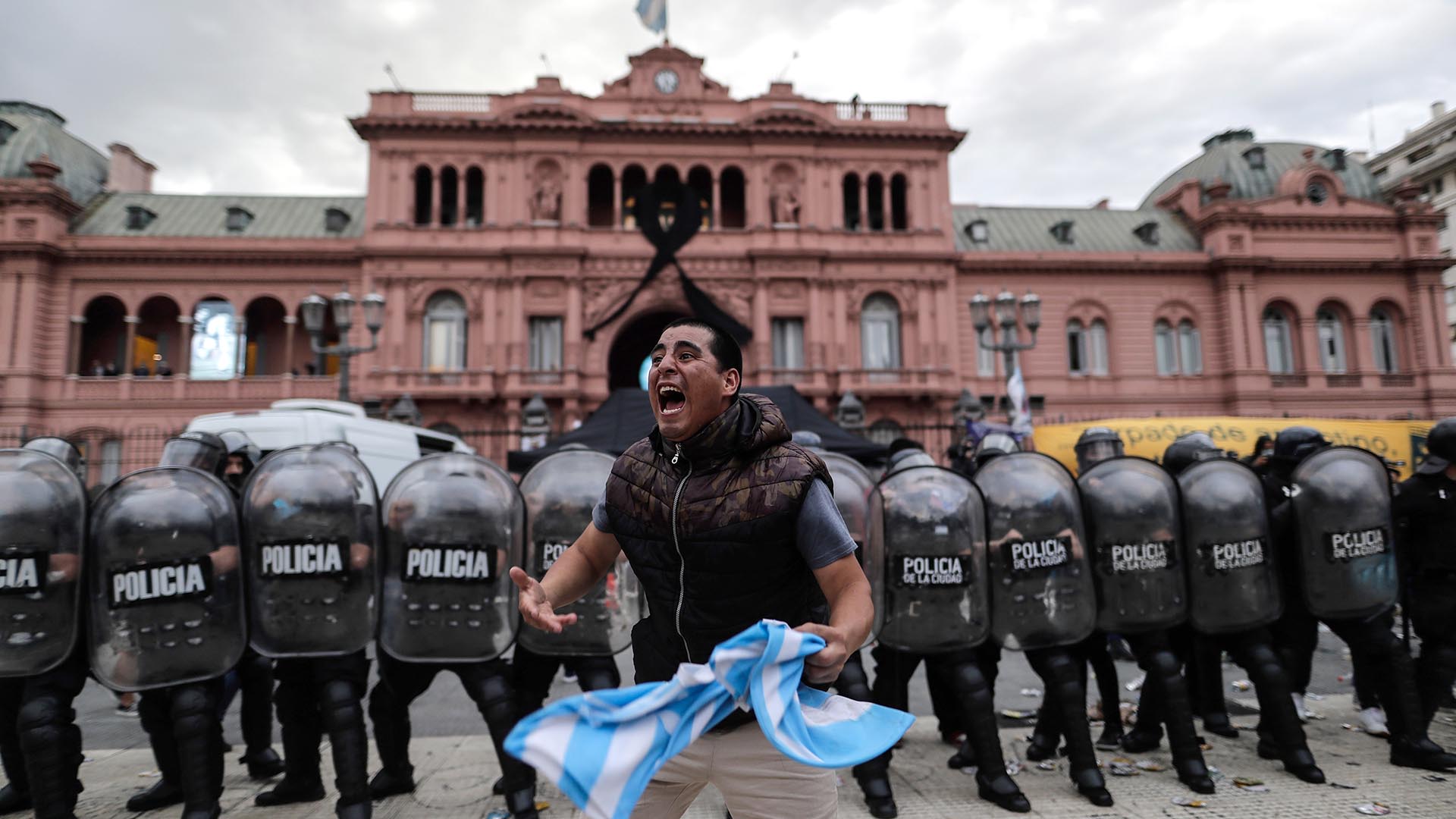 Un seguidor ante un grupo de efectivos de la Policía a las puertas de la Casa Rosada