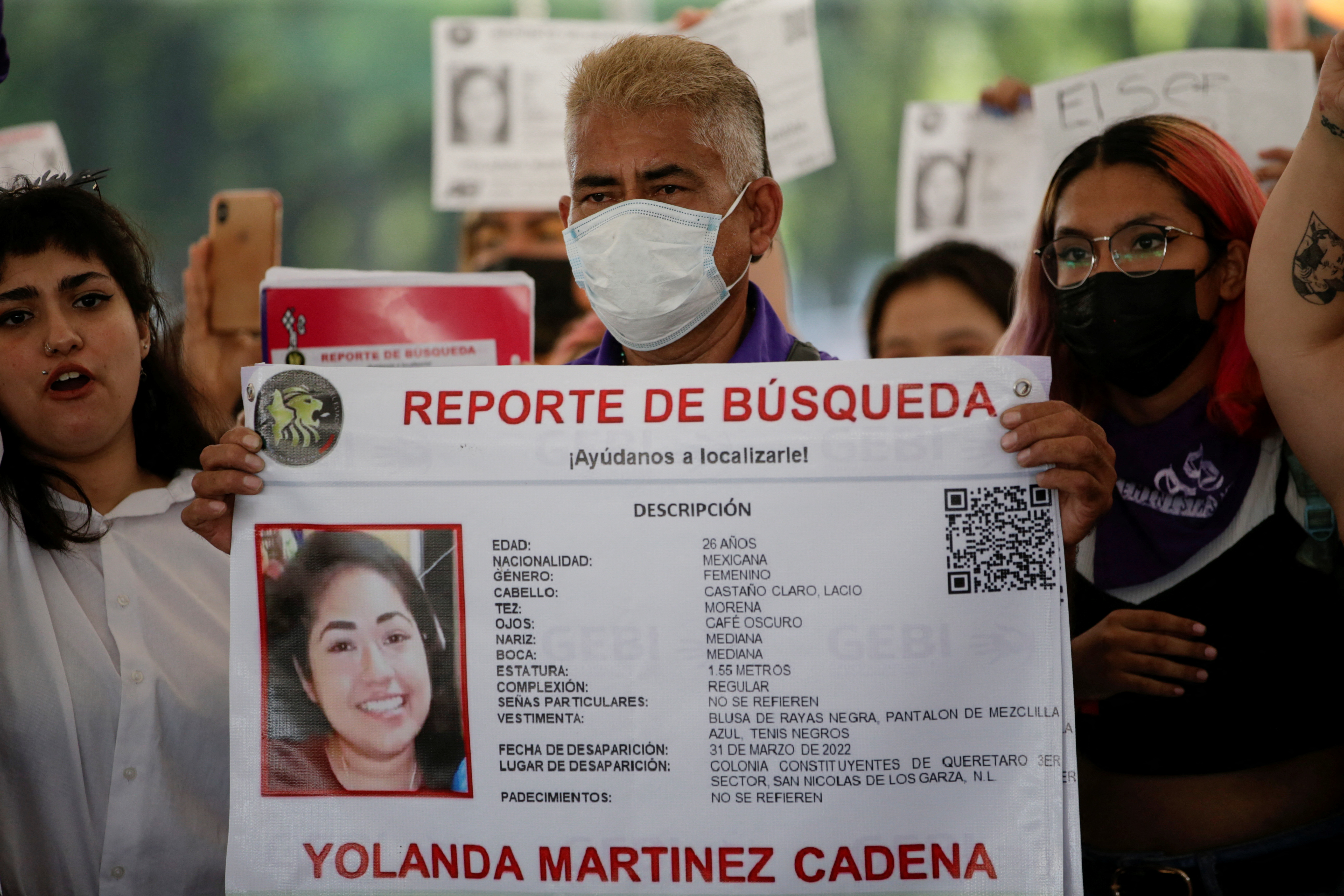 Gerardo Martinez, father of Yolanda Martinez, a 26-year-old woman who disappeared on March 31, holds a banner with information of his daughter during a protest demanding the government to find her alive, in Monterrey, Mexico April 29, 2022. REUTERS/Daniel Becerril