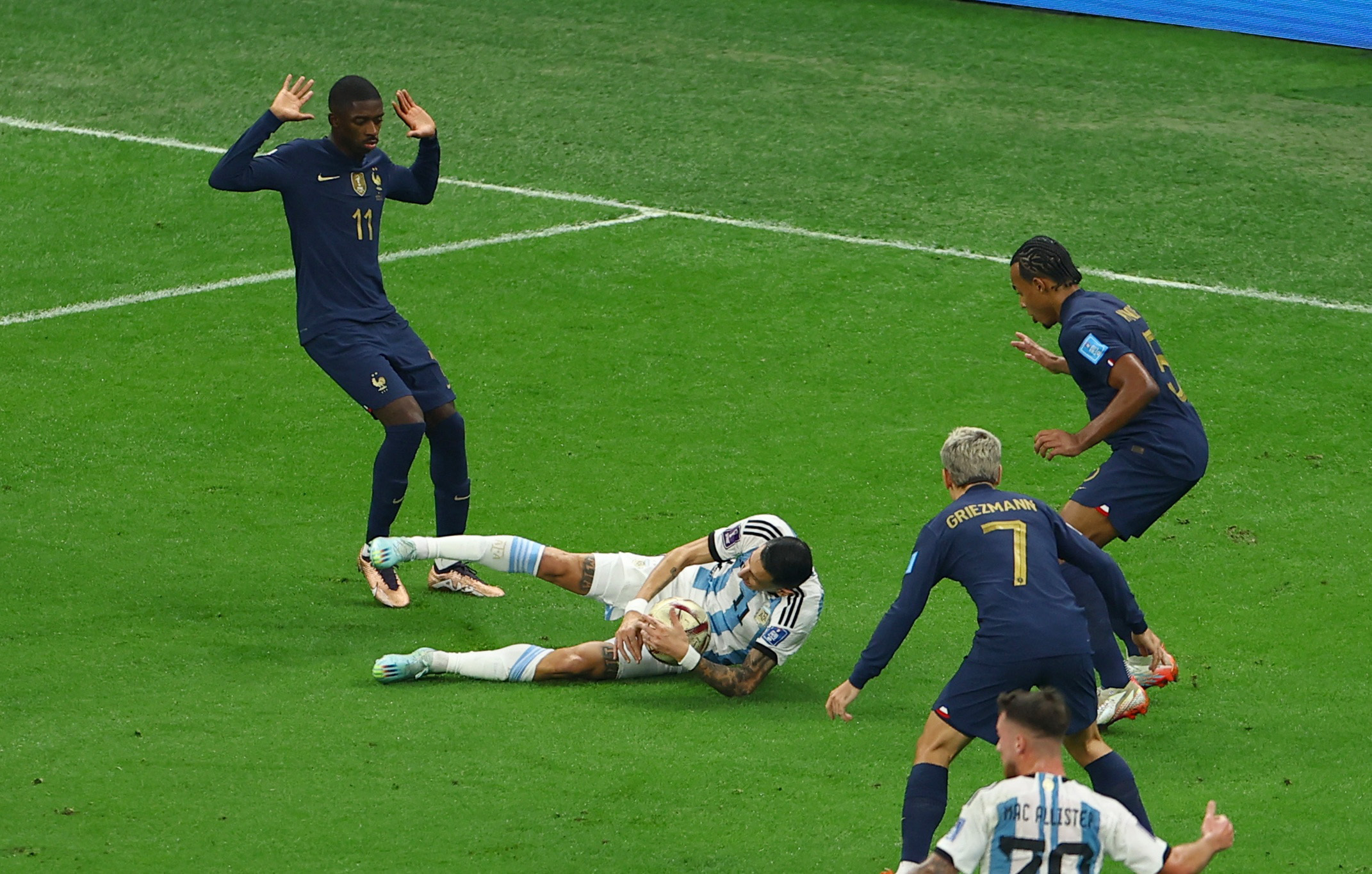 Soccer Football - FIFA World Cup Qatar 2022 - Final - Argentina v France - Lusail Stadium, Lusail, Qatar - December 18, 2022 Argentina's Angel Di Maria goes down under the challenge of France's Ousmane Dembele before referee Szymon Marciniak awards a penalty to Argentina REUTERS/Molly Darlington
