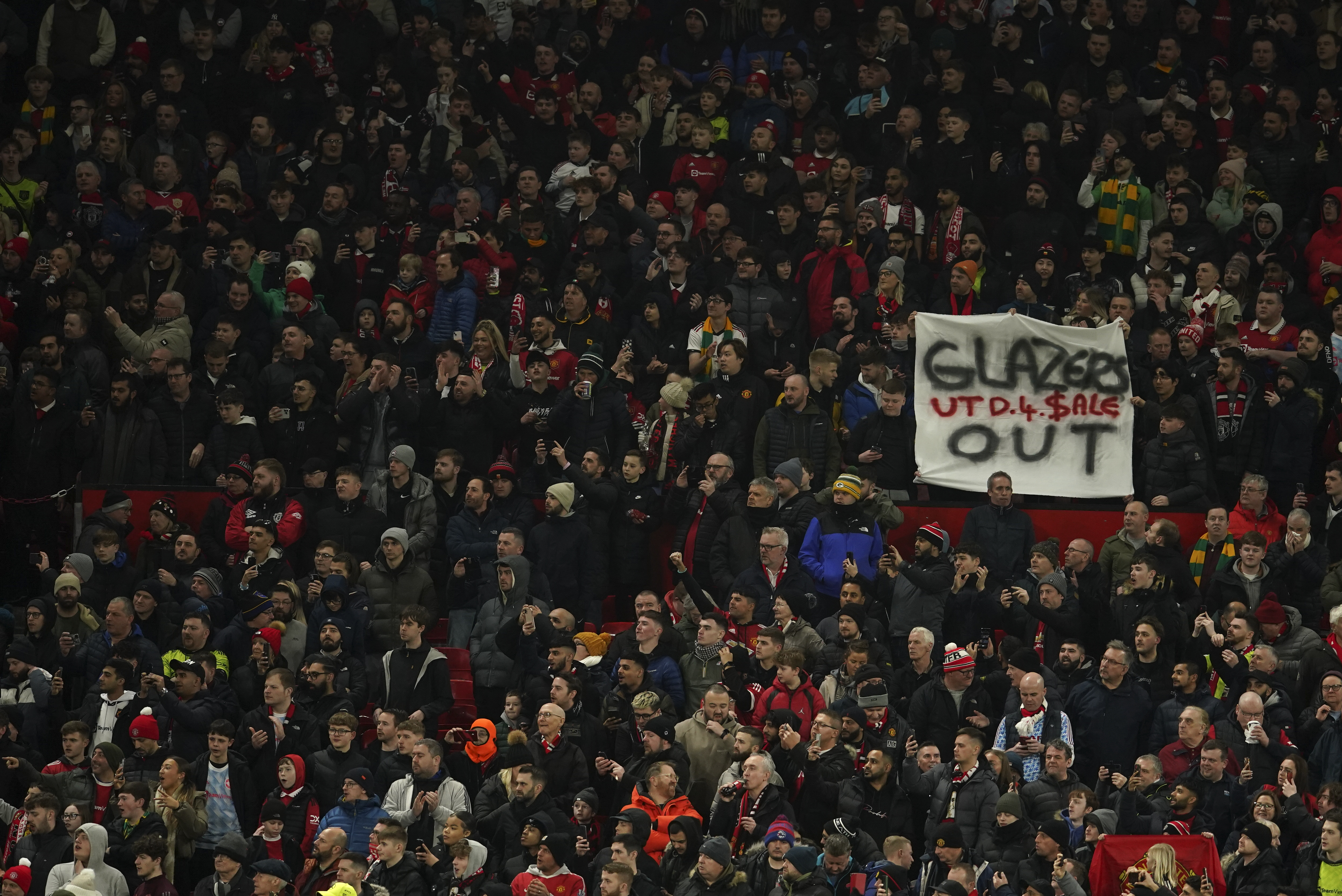 In this February 1, 2023 photo, Manchester United fans hold a banner that reads "Glazers Out" during the second leg of the League Cup semifinal.  On Friday, February 17, 2023, the deadline to submit offers to buy the team arrives.  (AP Photo/Dave Thompson)