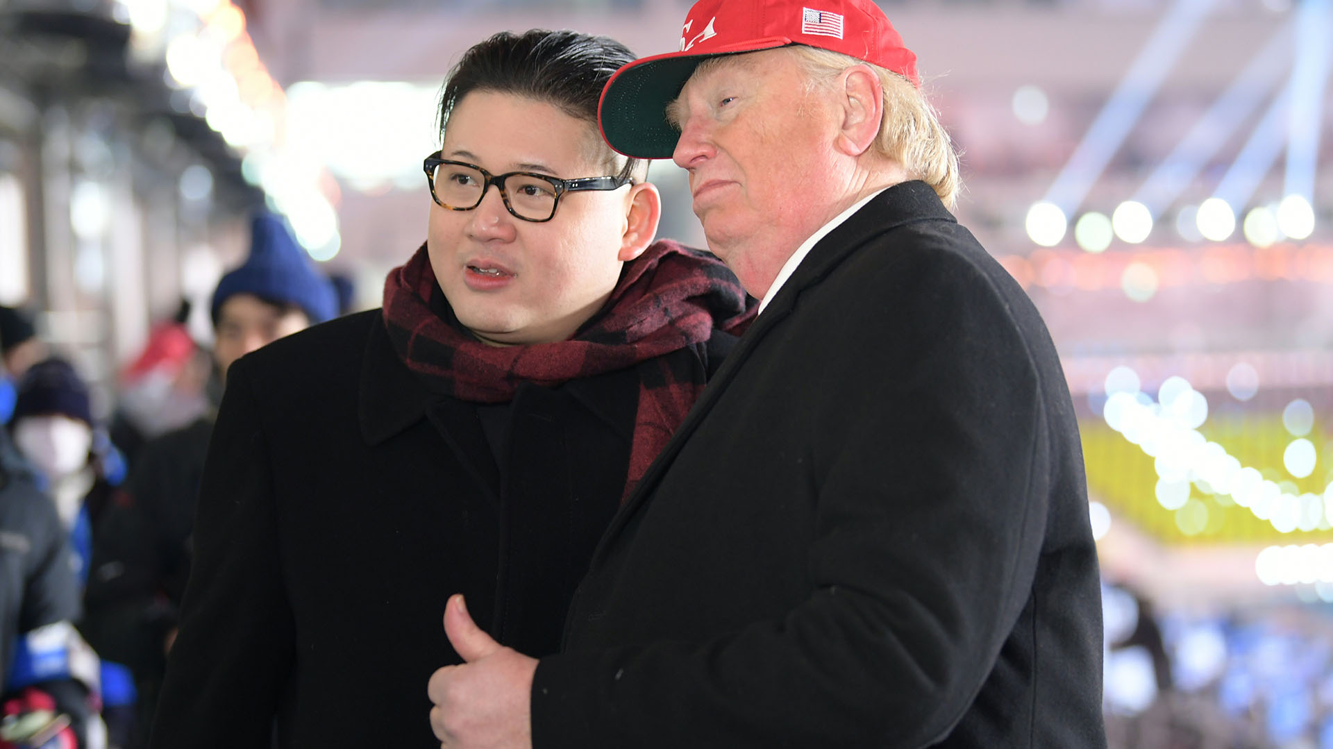 A man impersonating US President Donald Trump (R) and another impersonating Kim Jong-un pose in the stands during the opening ceremony of the Pyeongchang 2018 Winter Olympic Games at the Pyeongchang Stadium on February 9, 2018. / AFP PHOTO / MOHD RASFAN